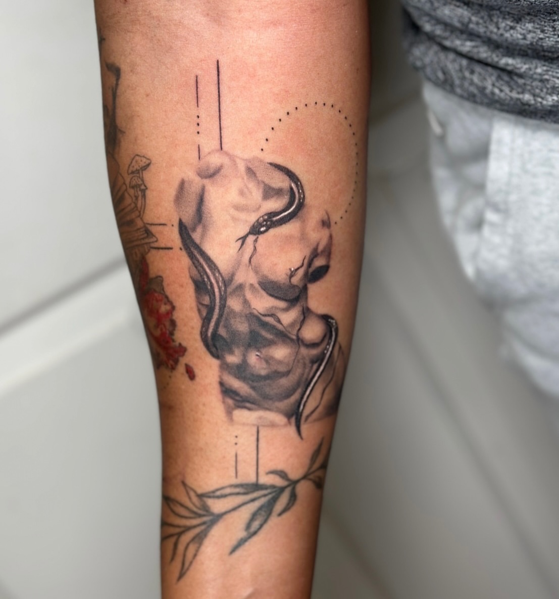 Snake and skull realism tattoo on the forearm by Nashville Tattoo Artist - Nicolette Madlyne
