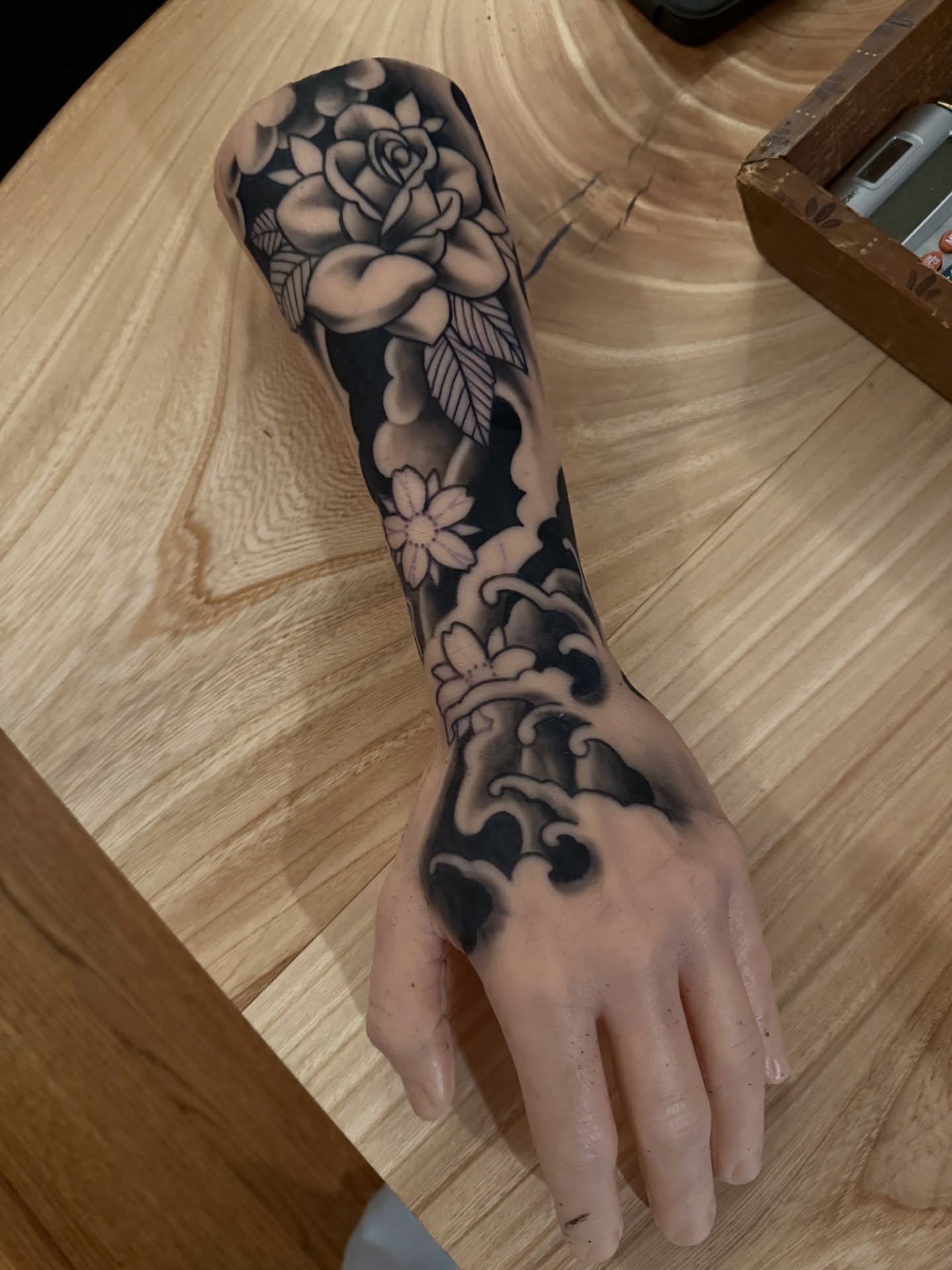 Floral sleeve black and grey tattoo on the forearm by Jeremy Utley