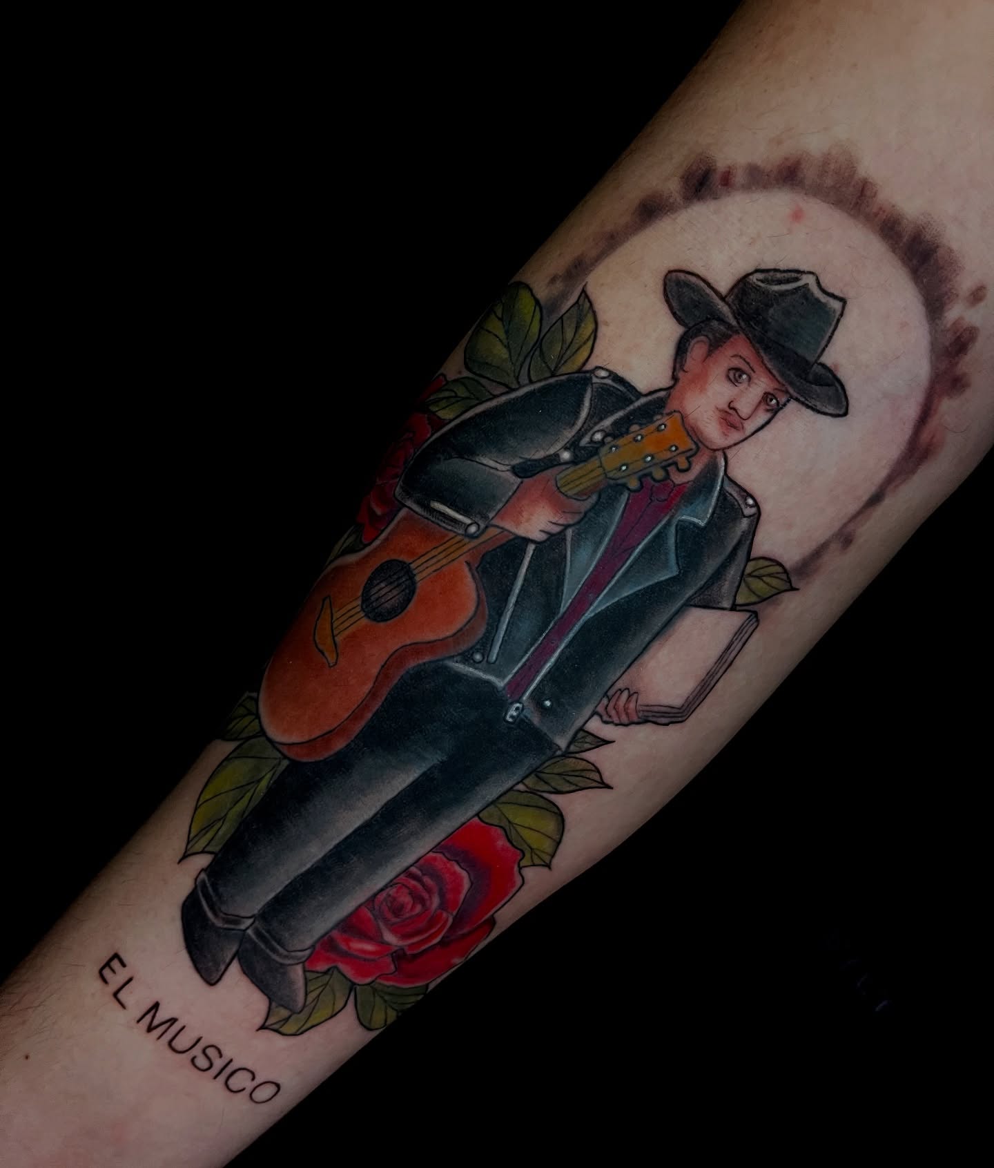 Musician with guitar American traditional tattoo on the forearm by Jessica Burridge