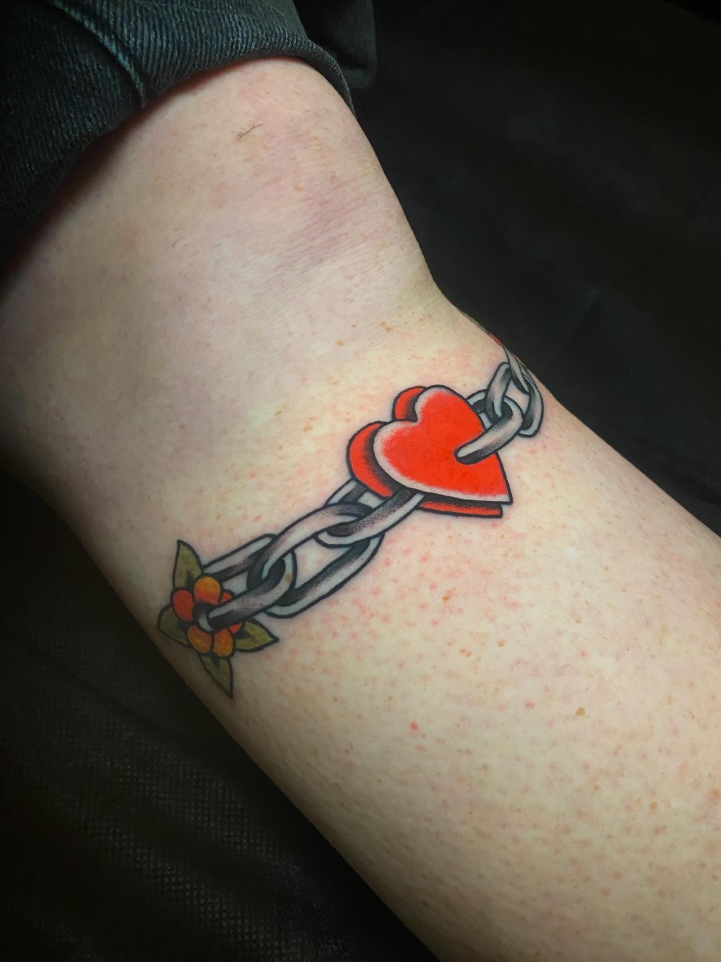 Heart and chain American traditional tattoo on the forearm by Jaclin Grace Hastings
