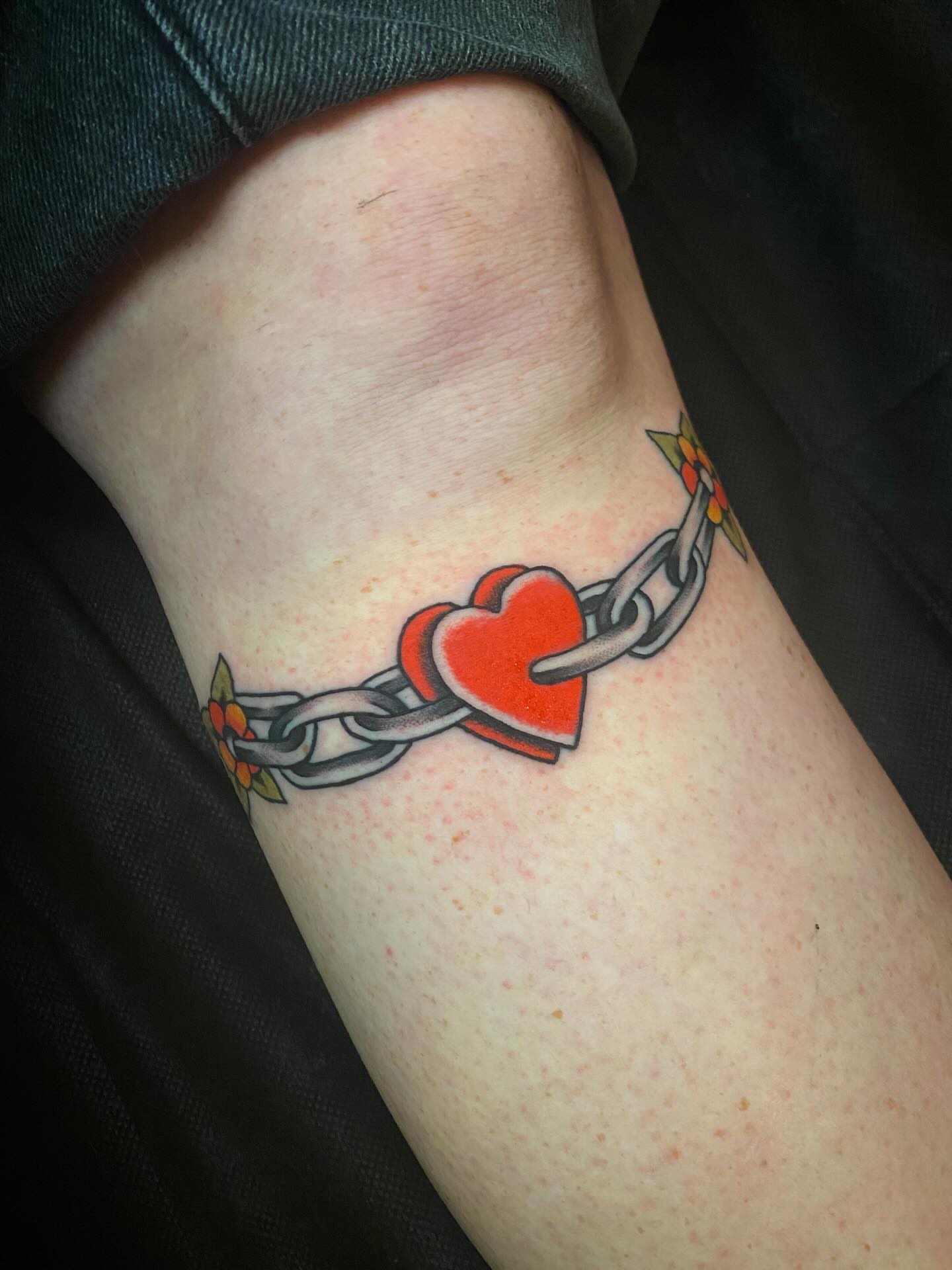 Heart and chain American traditional tattoo on the forearm by Jaclin Grace Hastings