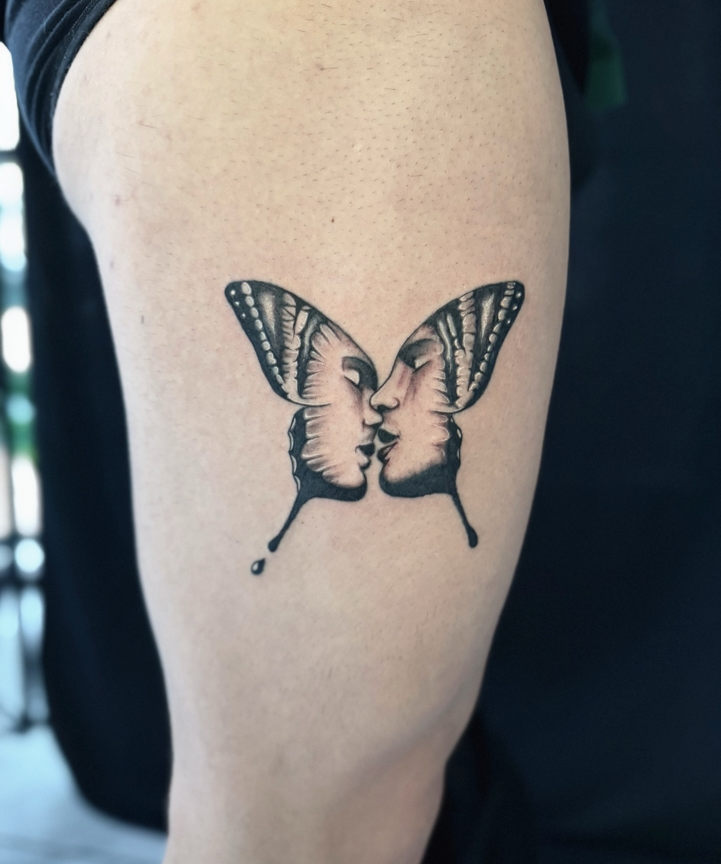 Kissing butterflies black and grey tattoo on the thigh by Miro Ink Tattoo