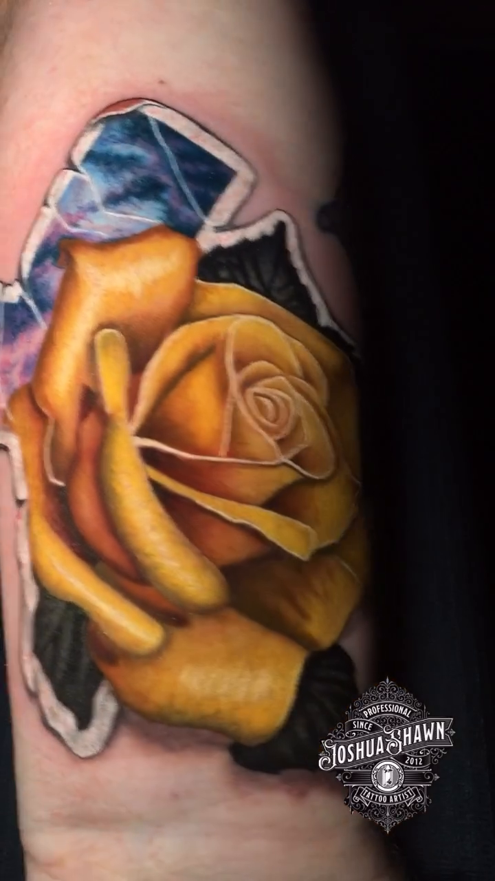 Yellow rose with blue crystals tattoo on the forearm by Joshua Shawn