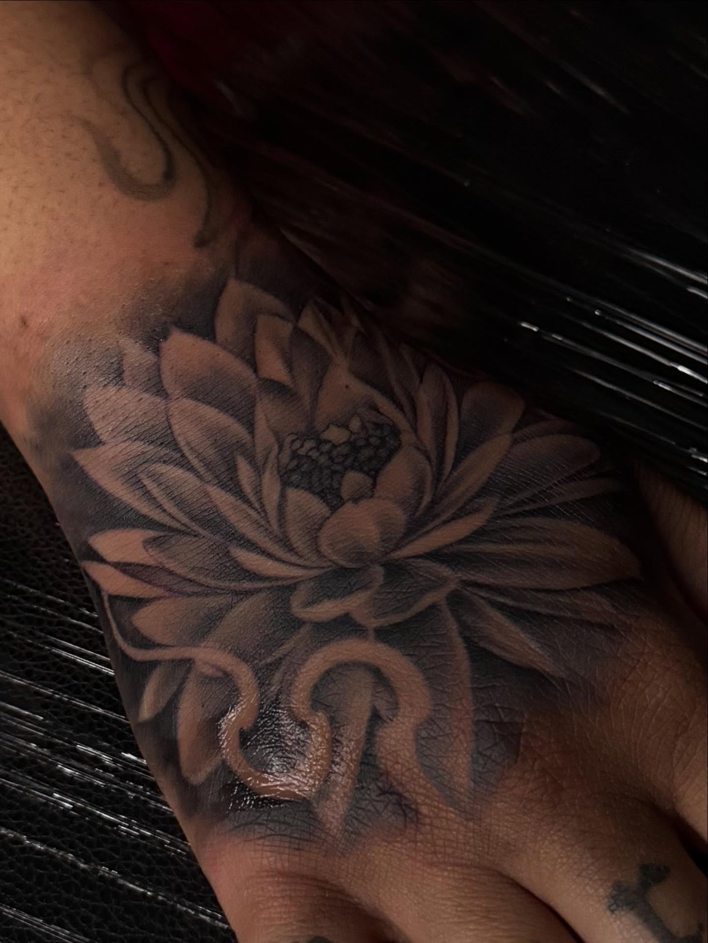 Flower black and grey tattoo on the forearm by Tattedbytrinn