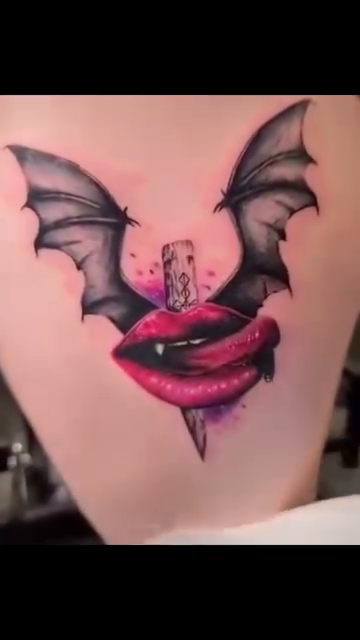 Bat wings with lips and dagger blackwork tattoo on the thigh by Drew King
