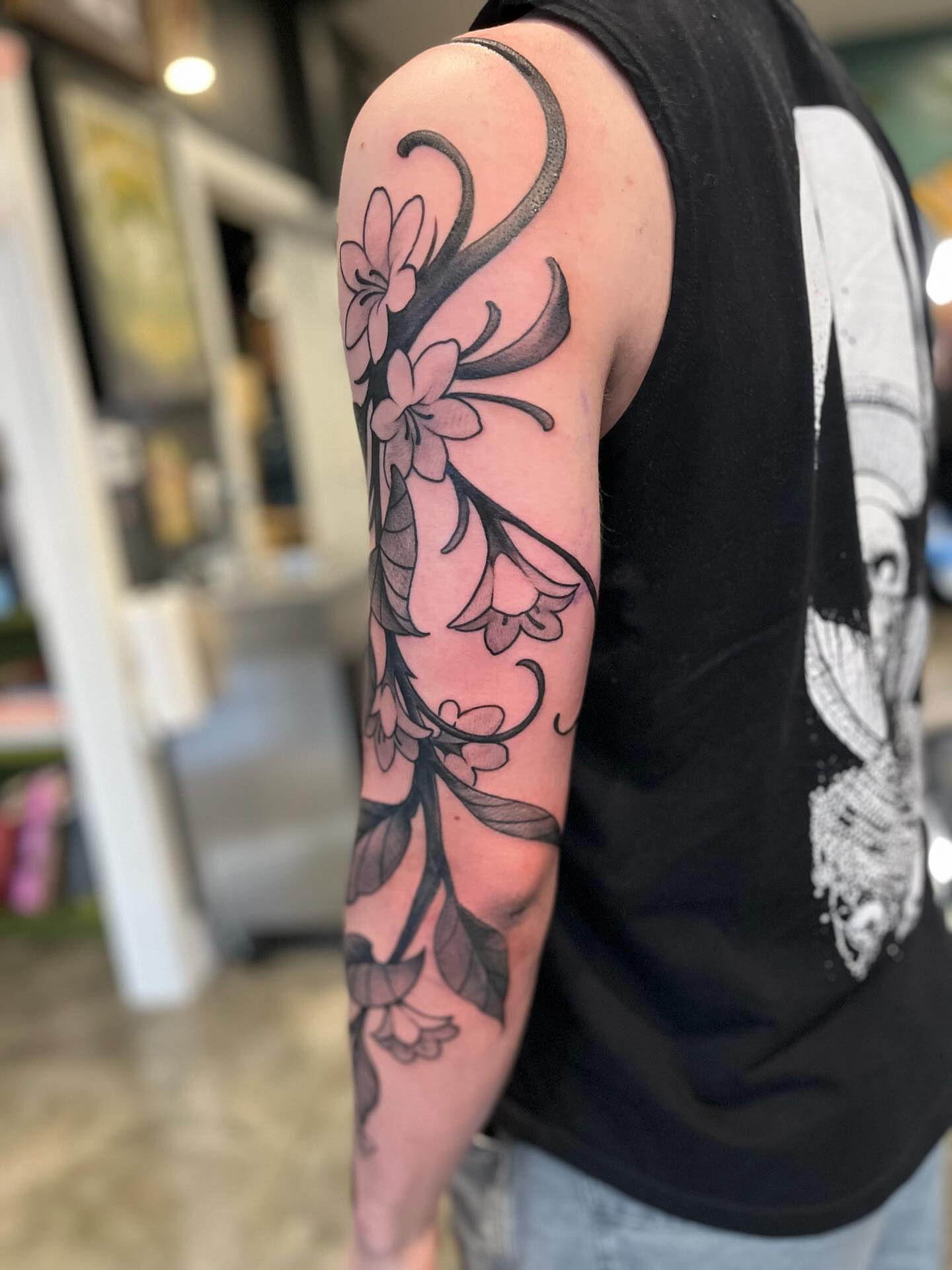 Floral vine black and grey tattoo on the forearm by Ian White