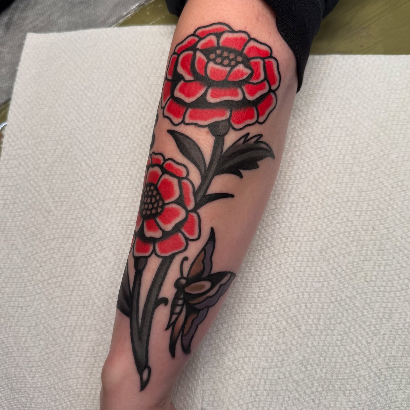 Flowers American traditional tattoo on the forearm by Erin Chambers