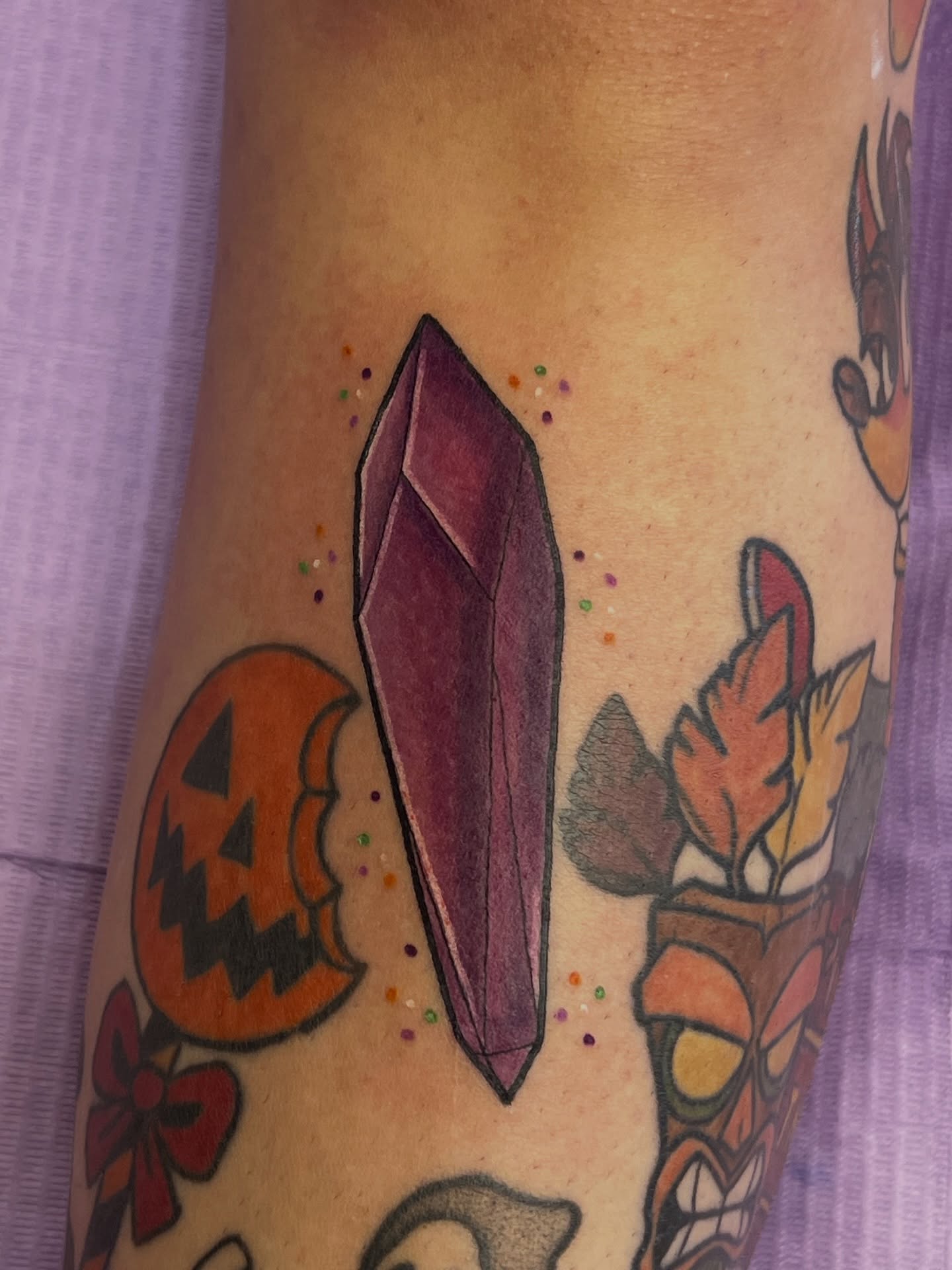 Purple crystal geometric tattoo on the forearm by Leslie Paskoff