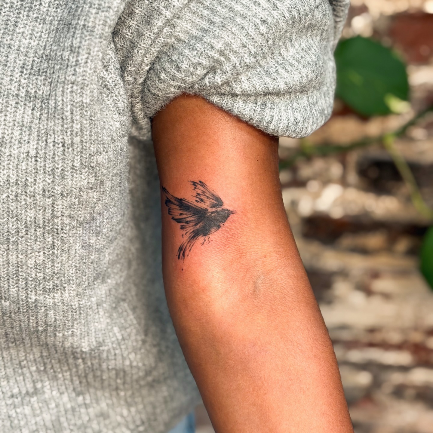 Bird black and grey tattoo on the forearm by justin