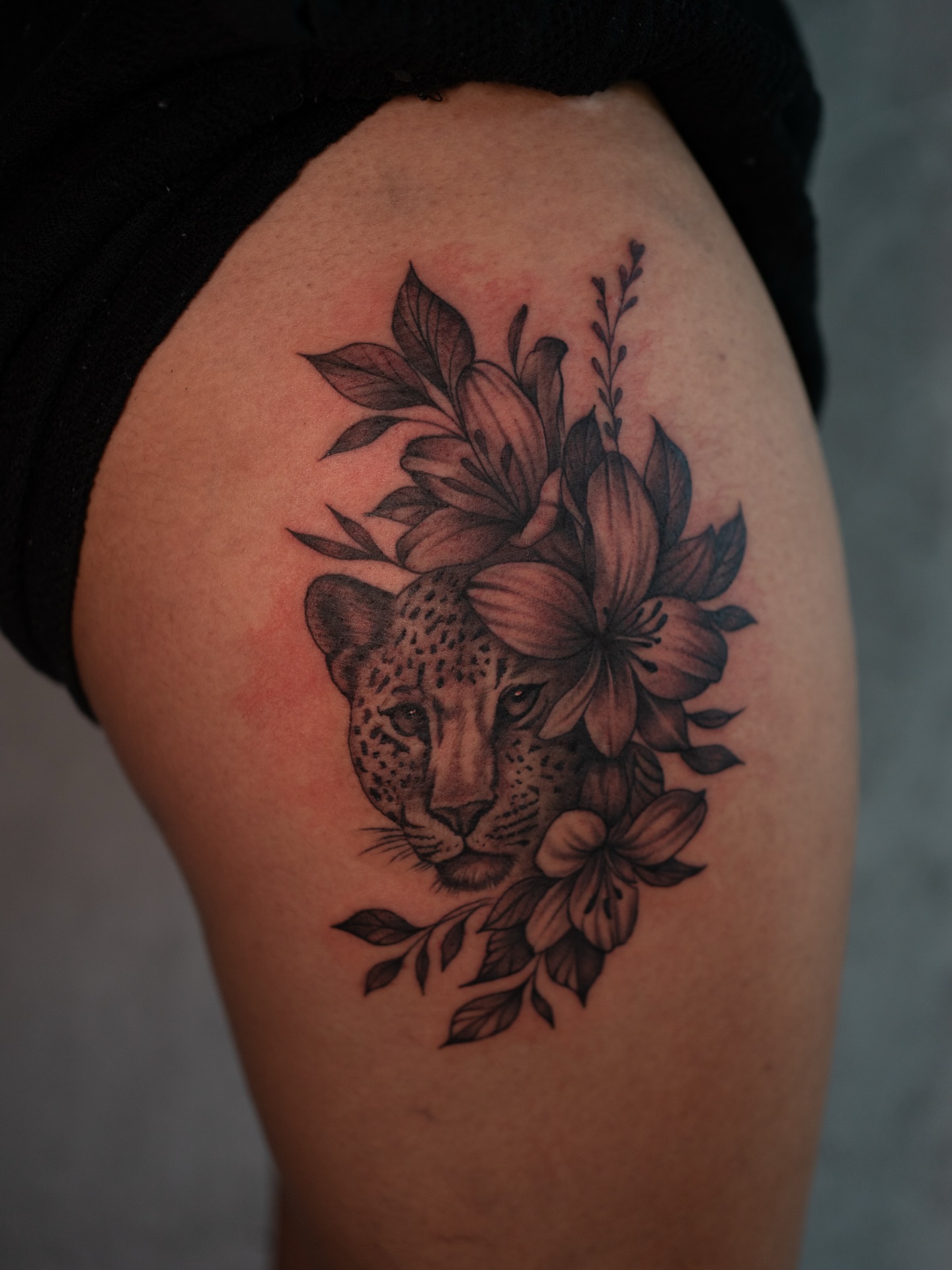Leopard with flowers realism tattoo on the thigh by Damon Valdez