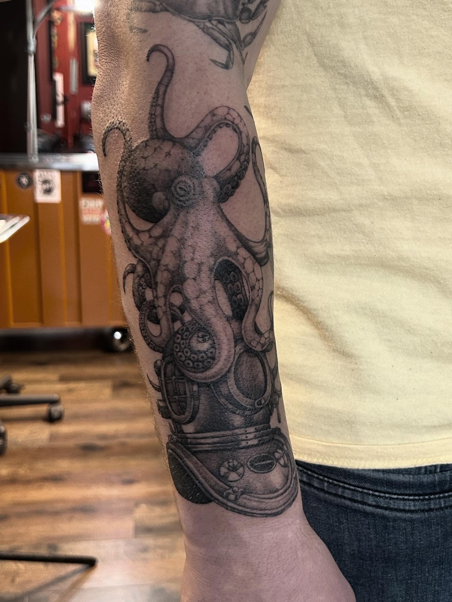 Octopus and diving helmet realism tattoo on the forearm by Tako, Seattle, Washington
