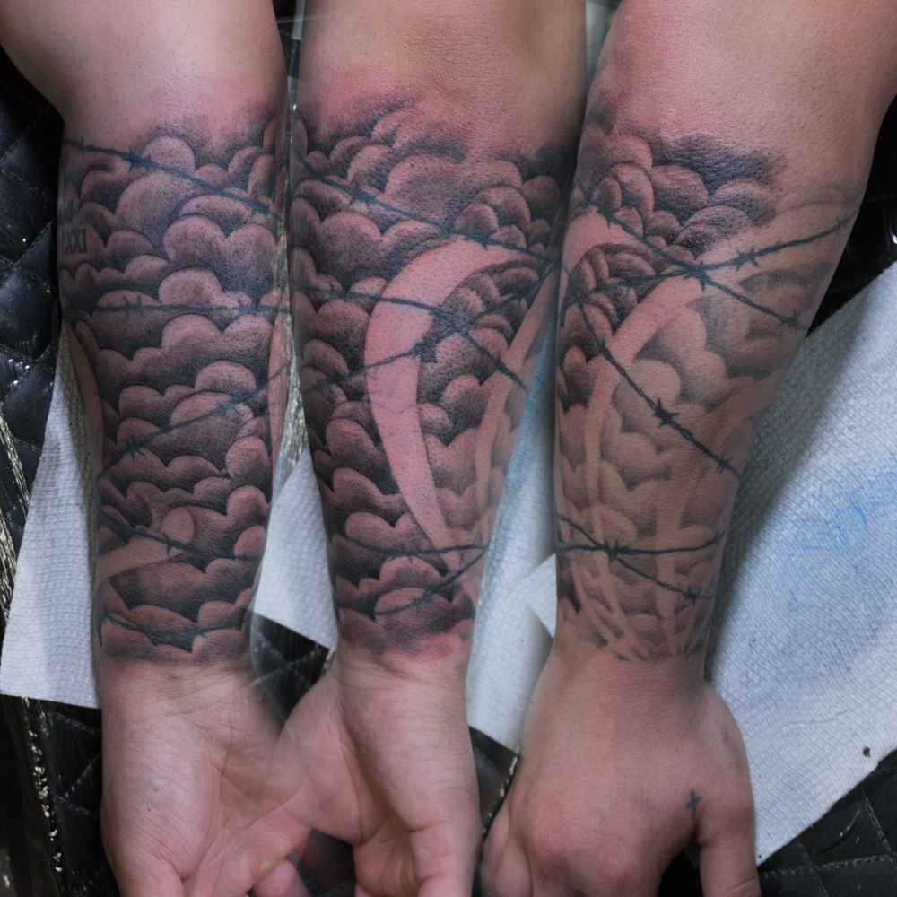 Barbed wire black and grey tattoo on the forearm by Donald Voelker