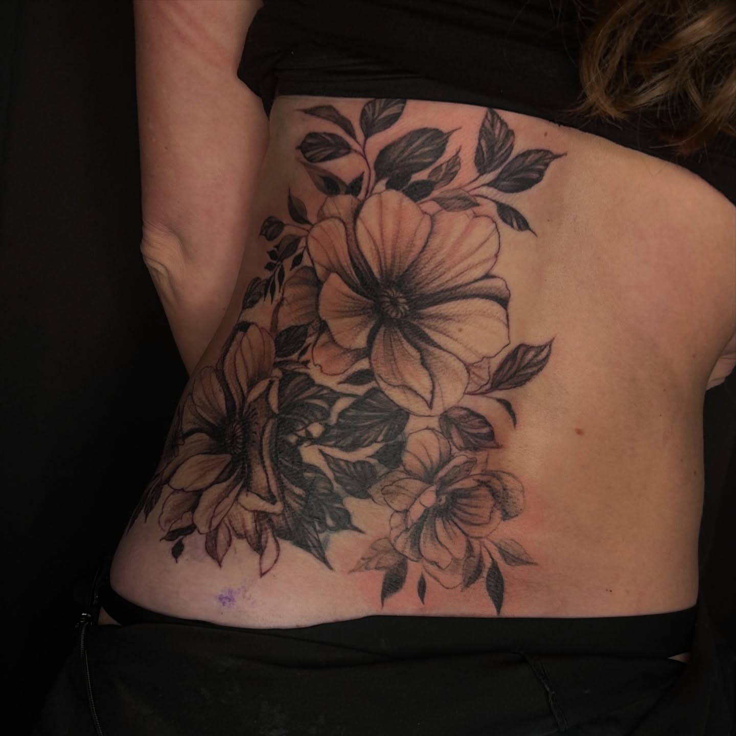 Floral bouquet black and grey tattoo on the ribs by Haley