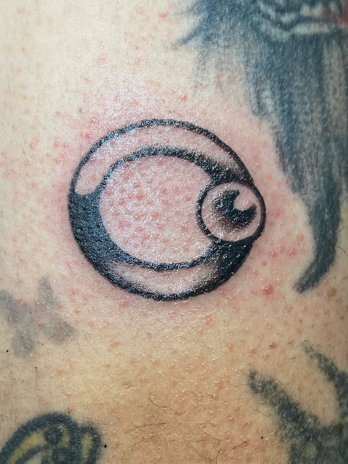Eye black and grey tattoo on the chest by Corinne Carter