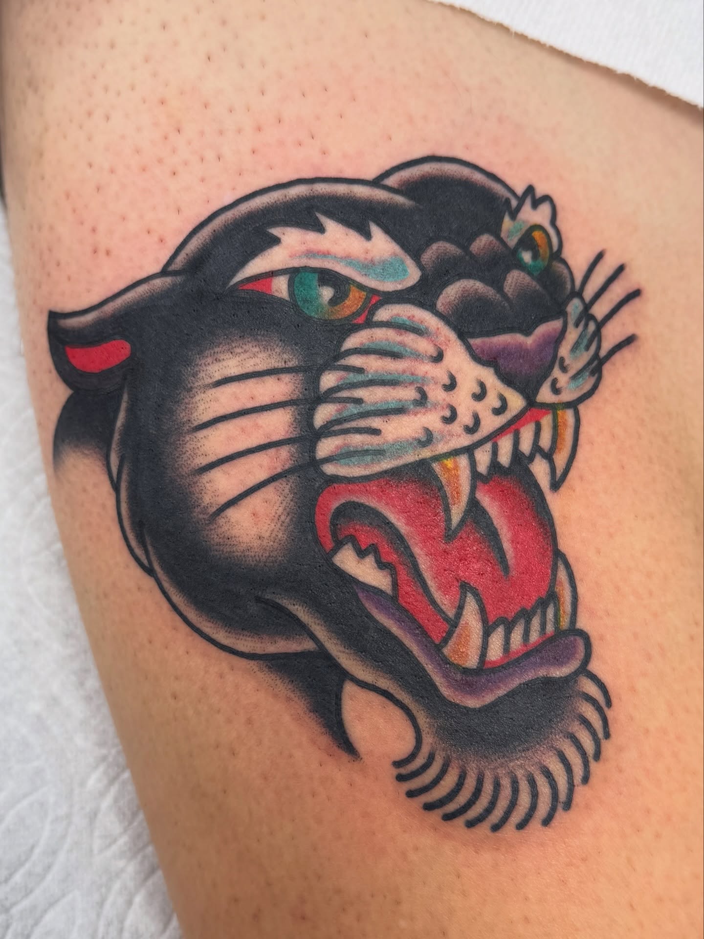 Panther American traditional tattoo on the thigh by Joey Burdette Tattoos