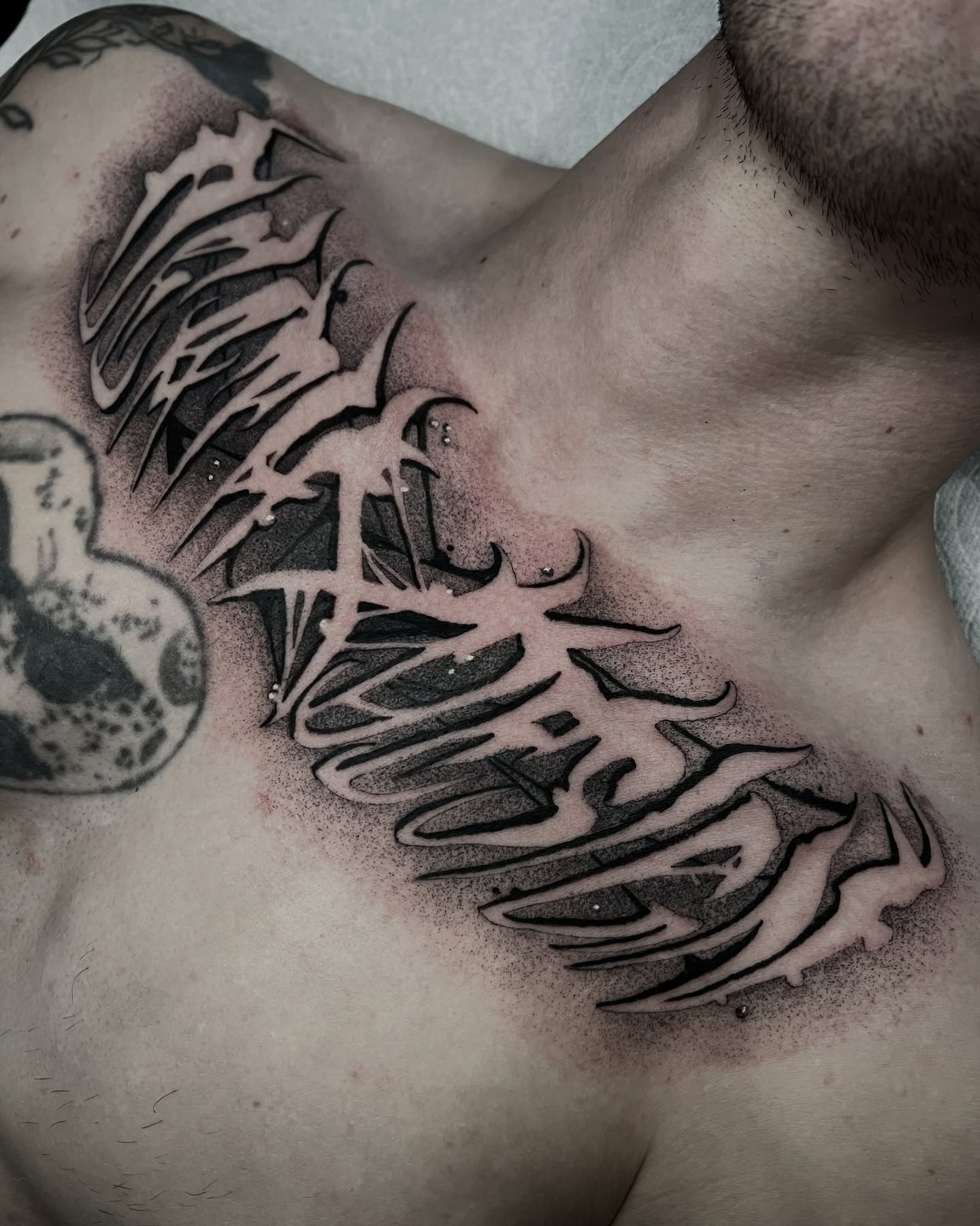 Tribal wings tribal tattoo on the chest by Las Vegas Tattoo Artist
