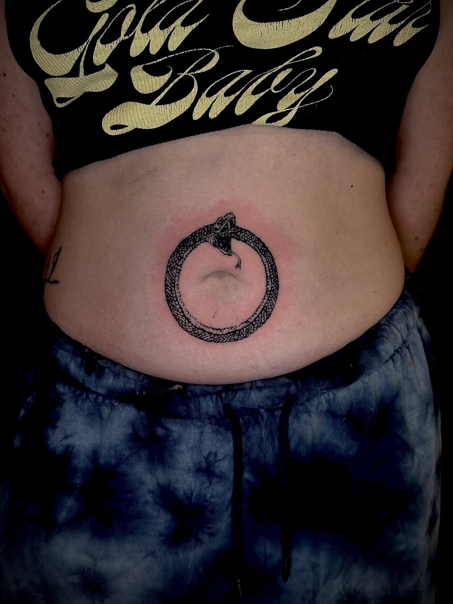 Snake black and grey tattoo on the torso by Thomas Martinez
