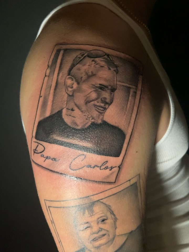 Portrait black and grey tattoo on the upper arm by Chris Torres