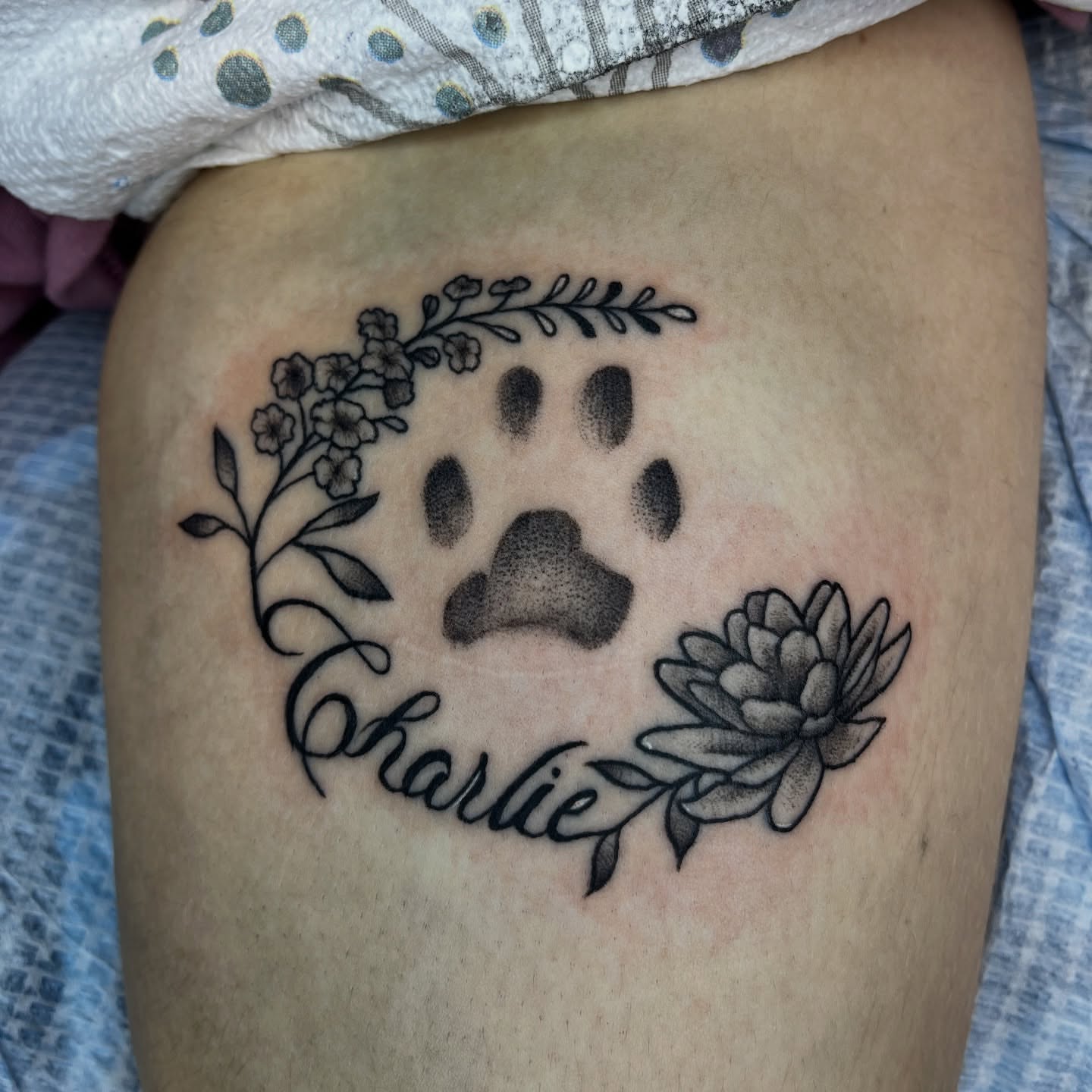 Paw print with floral wreath dotwork tattoo on the thigh by Anya💋~NC Tattoo Artist