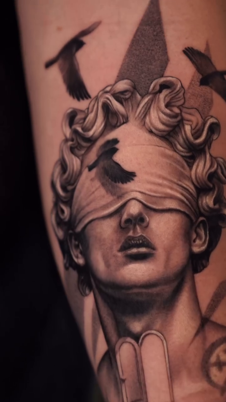 Blindfolded statue head with birds realism tattoo by J O S S I e L P I N e D A