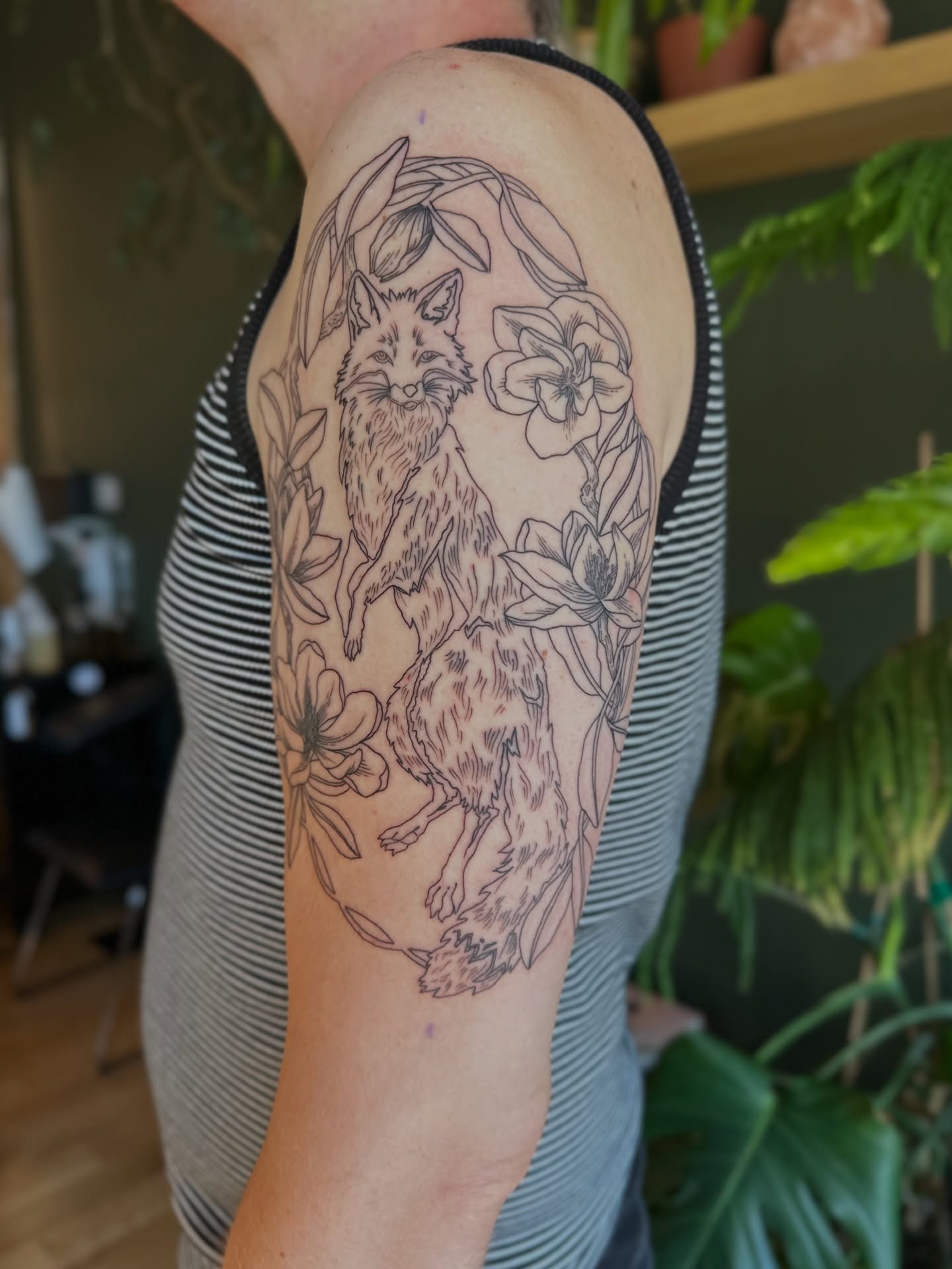 Foxes and flowers black and grey tattoo on the forearm by Alexandra Gray