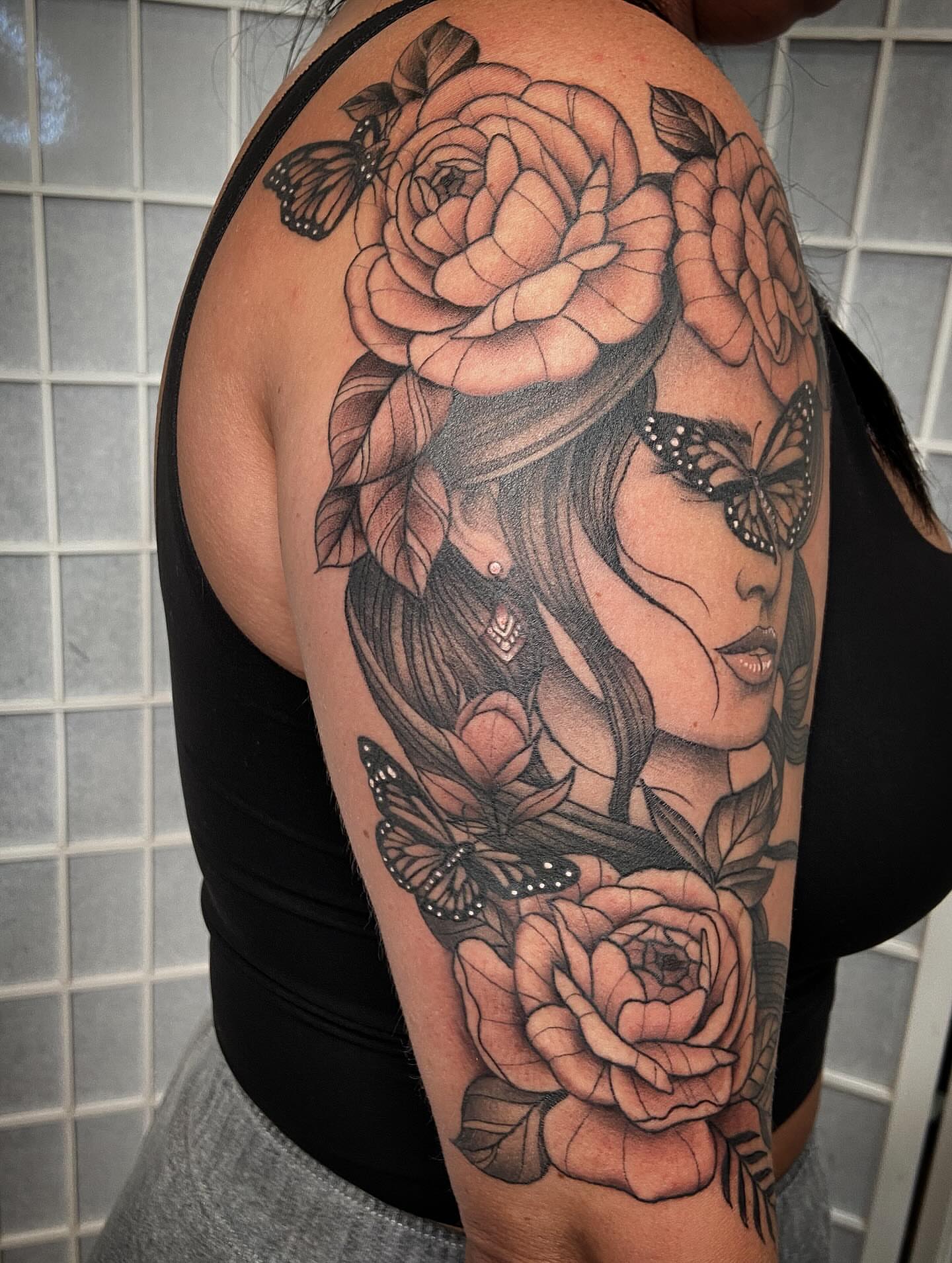 Woman with roses and butterflies realism tattoo on the shoulder by Tattoos by Dale Hupke, Lebanon, Ohio