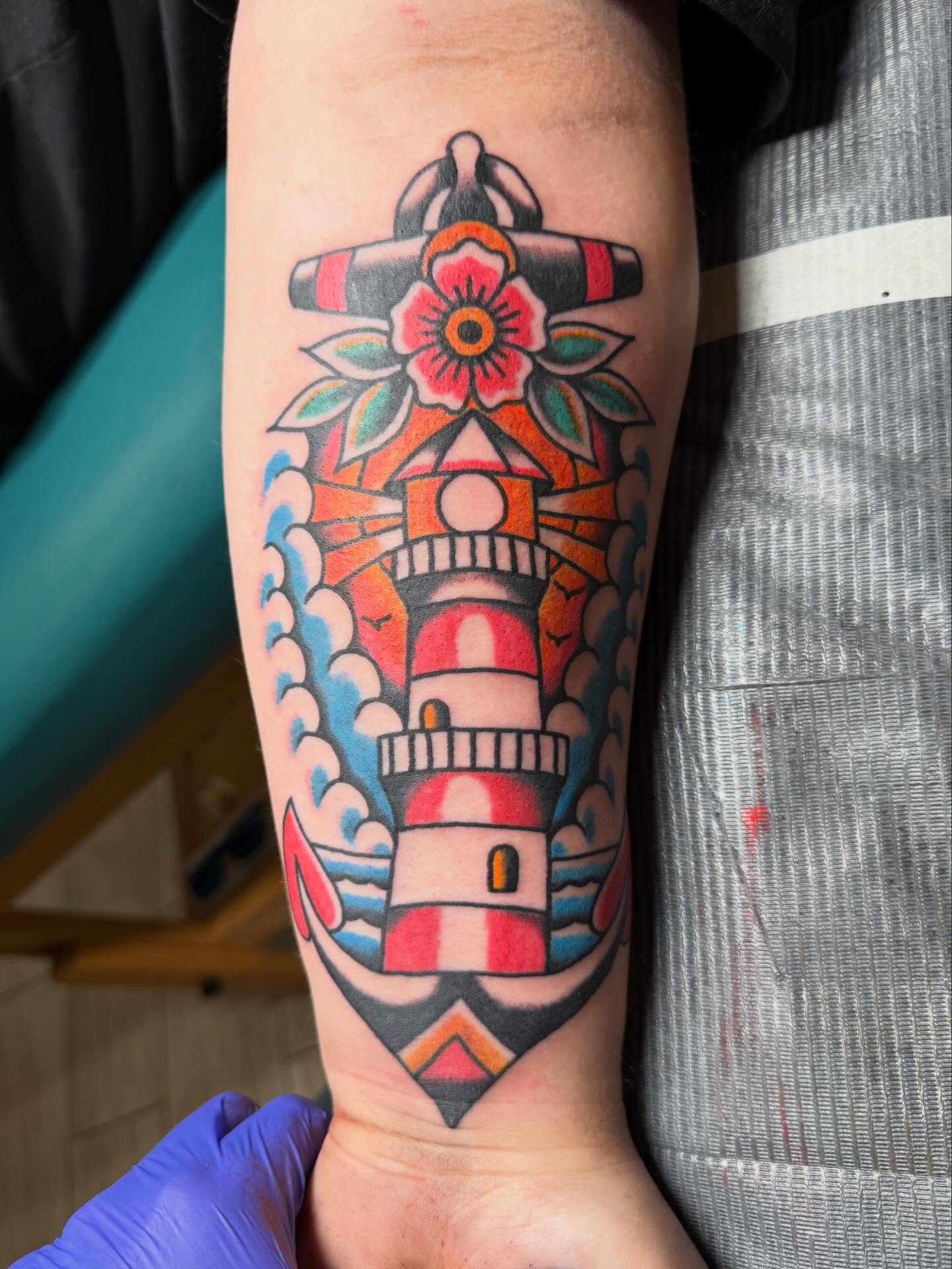 Lighthouse American traditional tattoo on the forearm by Bill Crawford, Plymouth, Michigan