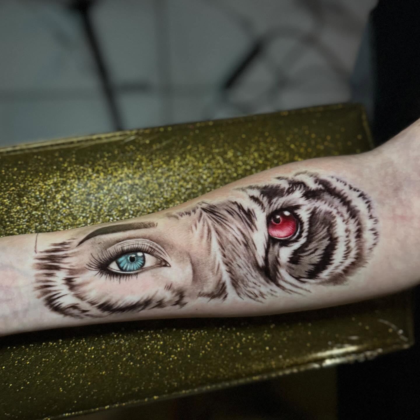 Eye and tiger realism tattoo on the forearm by Marquis Neal