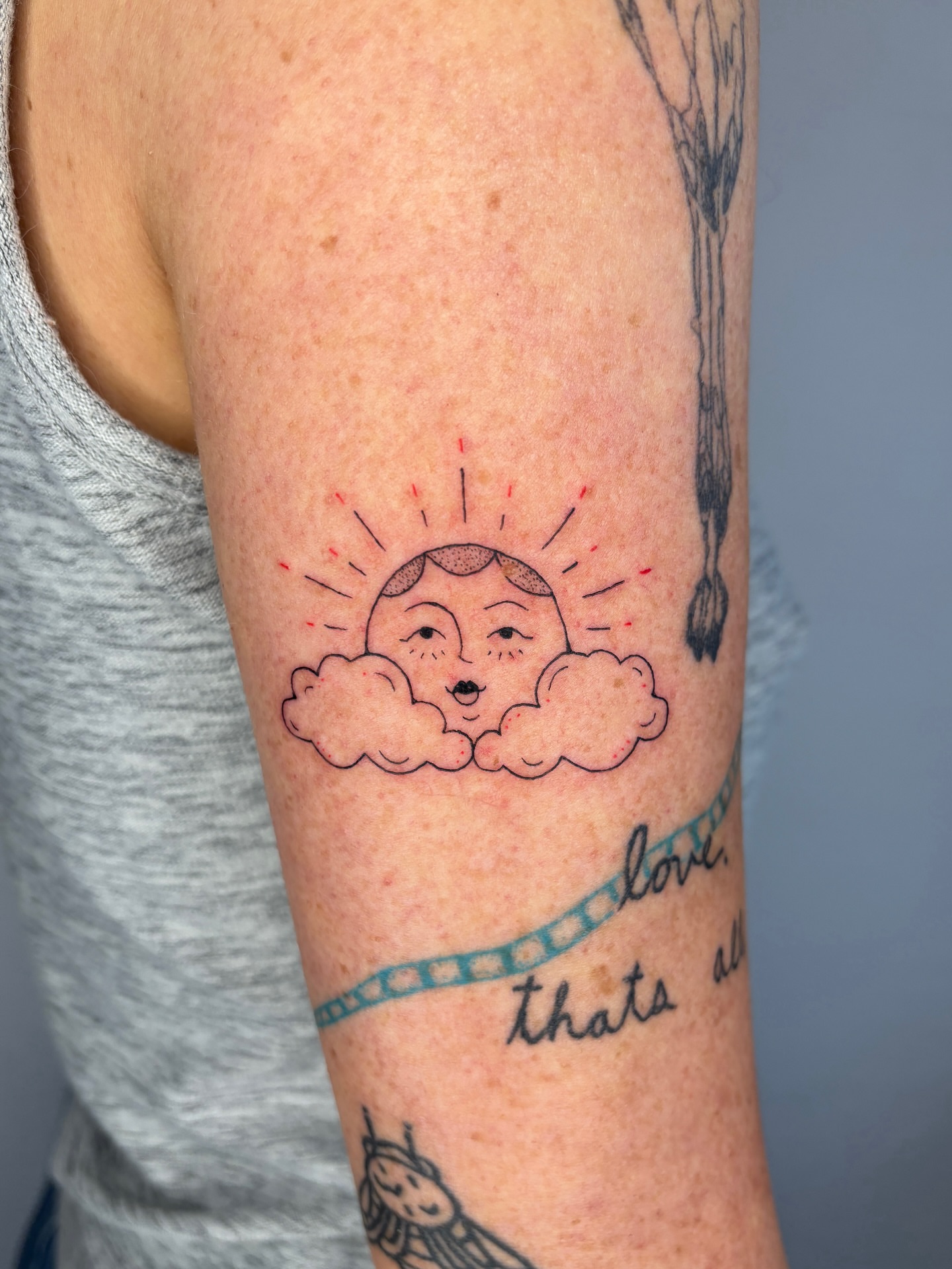 Sun and clouds dotwork tattoo on the forearm by Raye