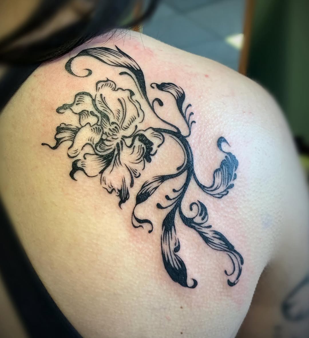 Flower and vine fine line tattoo on the shoulder by Ava Glory Tattoos