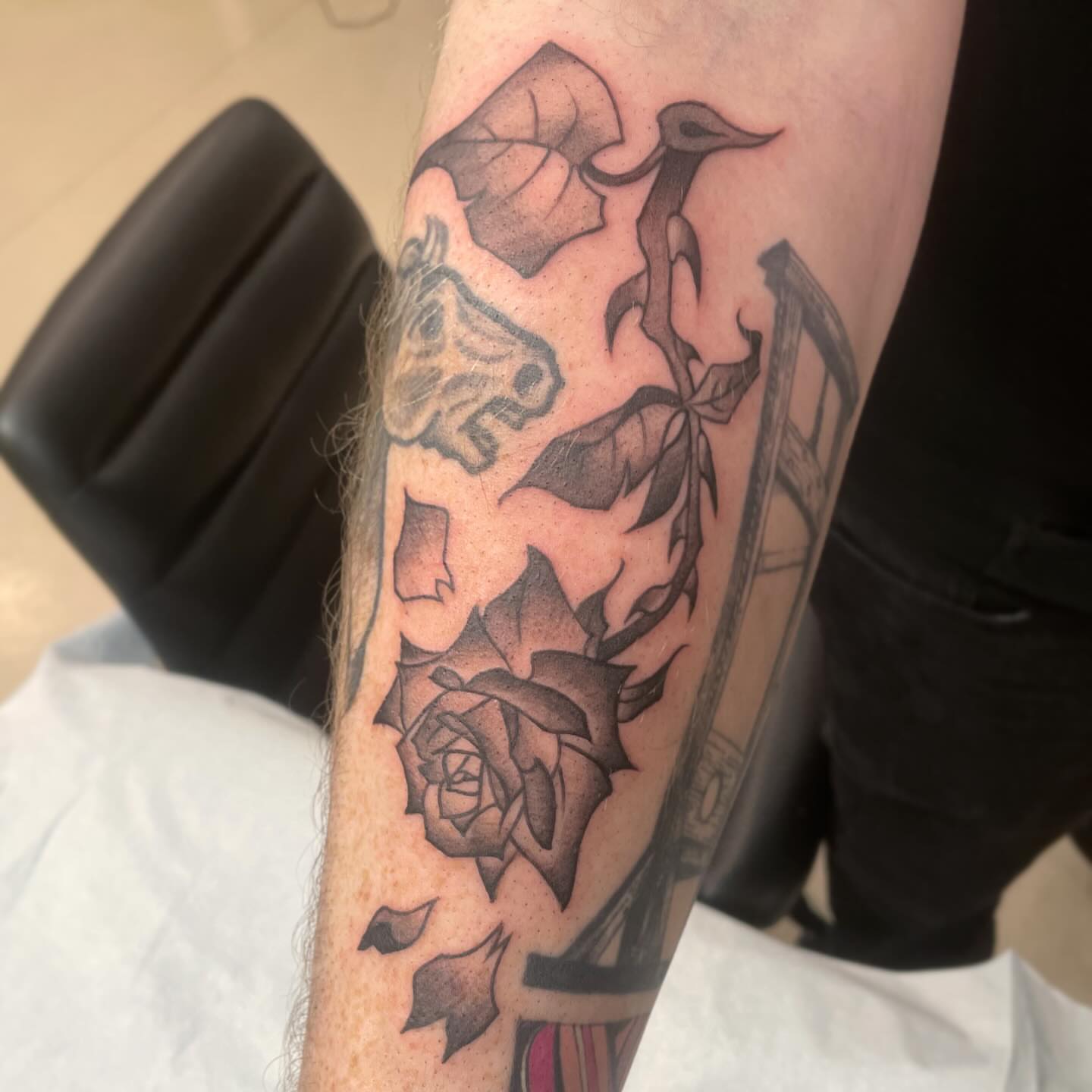 Rose and bird black and grey tattoo on the forearm by Ally Easter, Berkeley, California