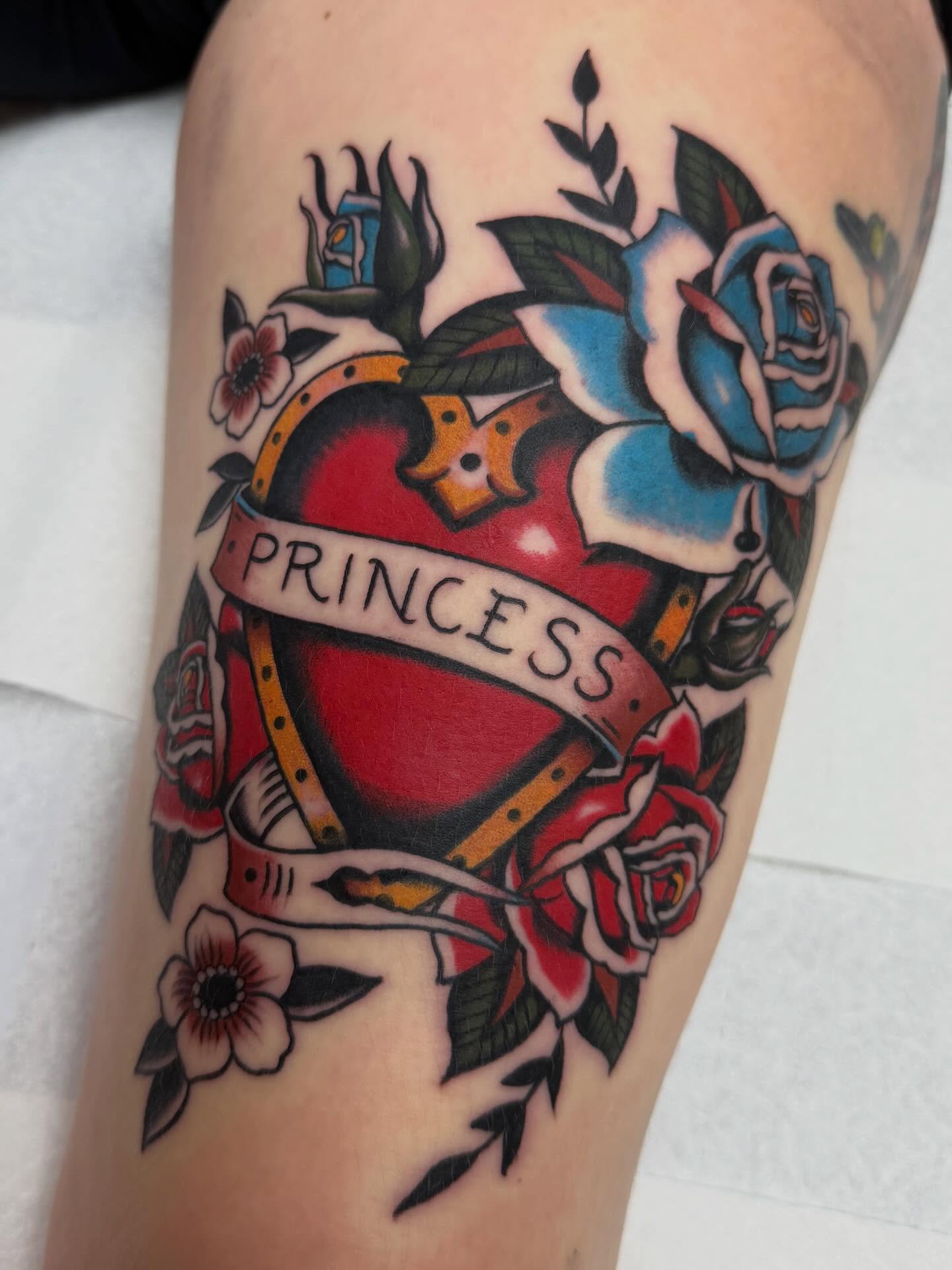 Heart with roses American traditional tattoo on the forearm by David Evans