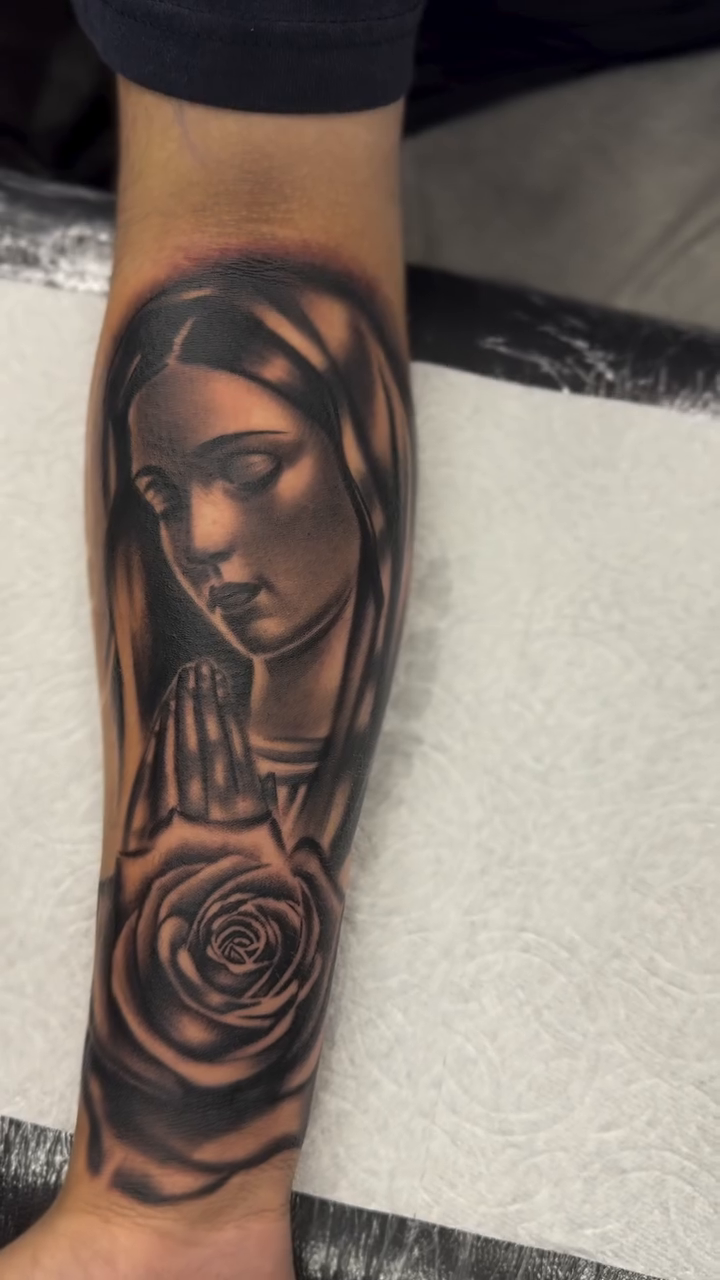 Virgin Mary with a rose realism tattoo by Alex Romero