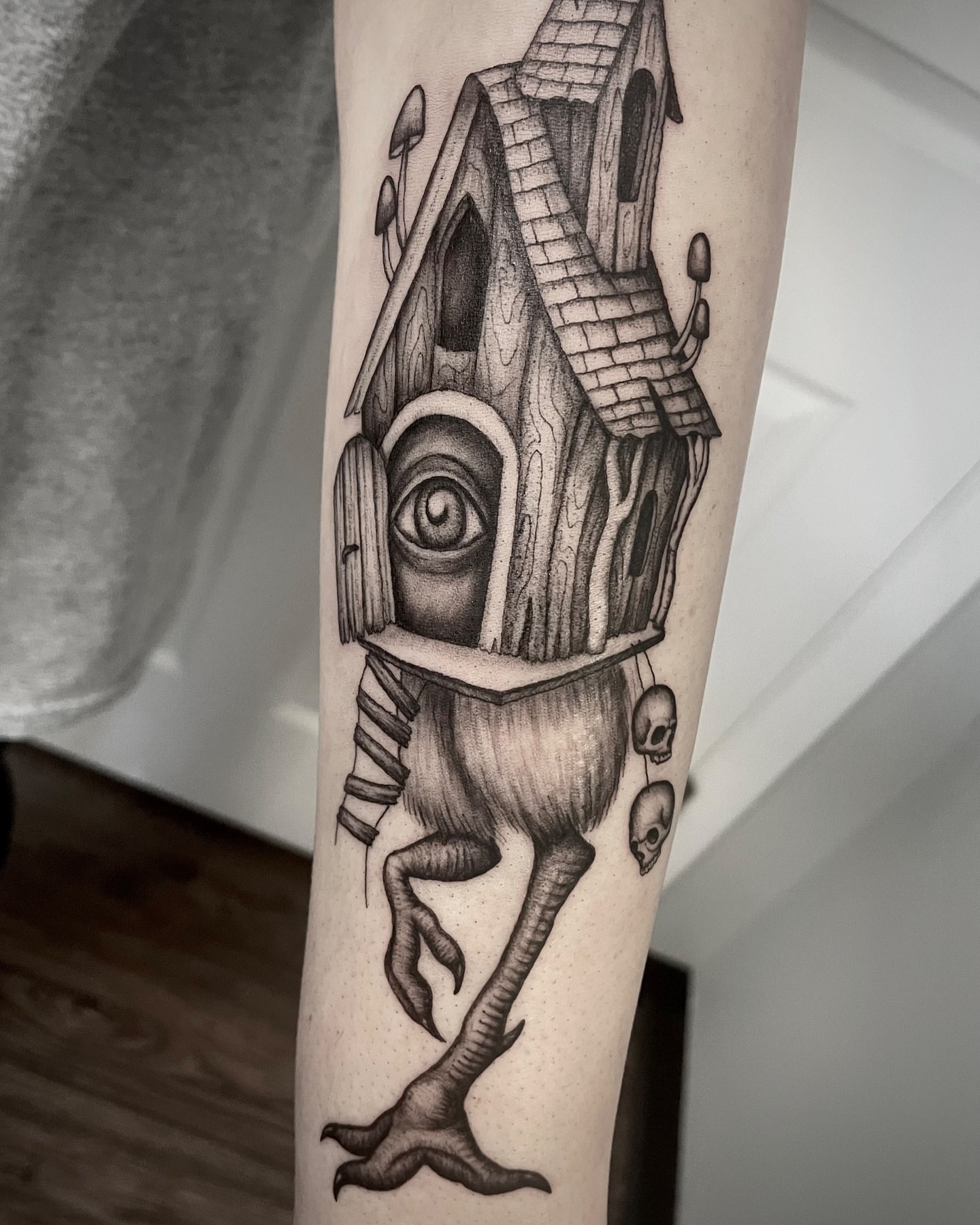 House with eyes surrealism tattoo on the forearm by @tatts_by_kat