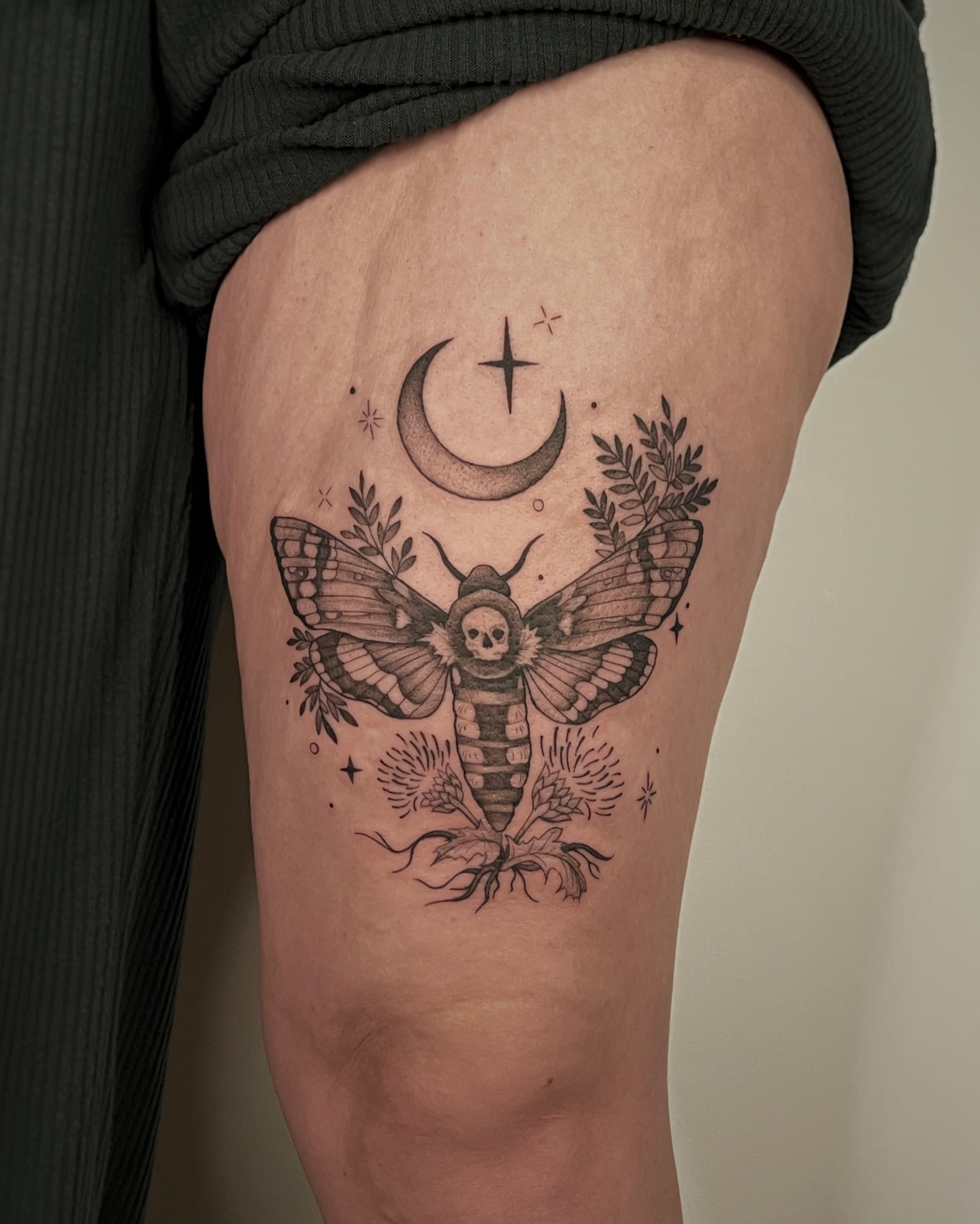 Moth with skull black and grey tattoo on the thigh by Mikayla Sue