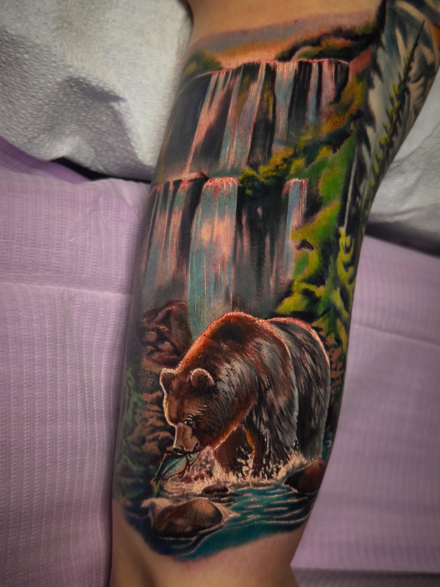 Bear fishing realism tattoo on the thigh by Eric Zuluaga