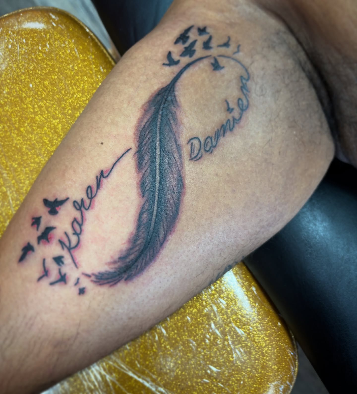 Feather with names black and grey tattoo on the forearm by adamsayre, San Diego, California