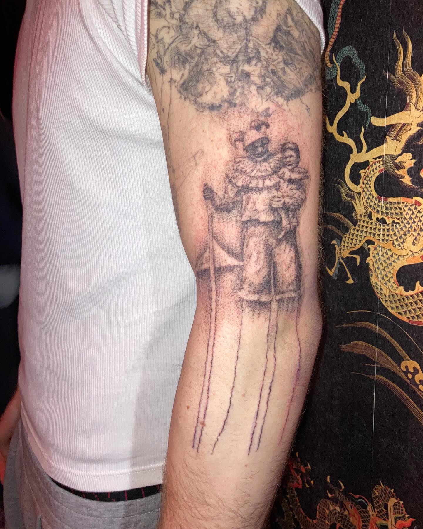 Clown and child black and grey tattoo on the forearm by Gregory Bramble Tattoo ๐ด๓ ง๓ ข๓ ฅ๓ ฎ๓ ง๓ ฟ