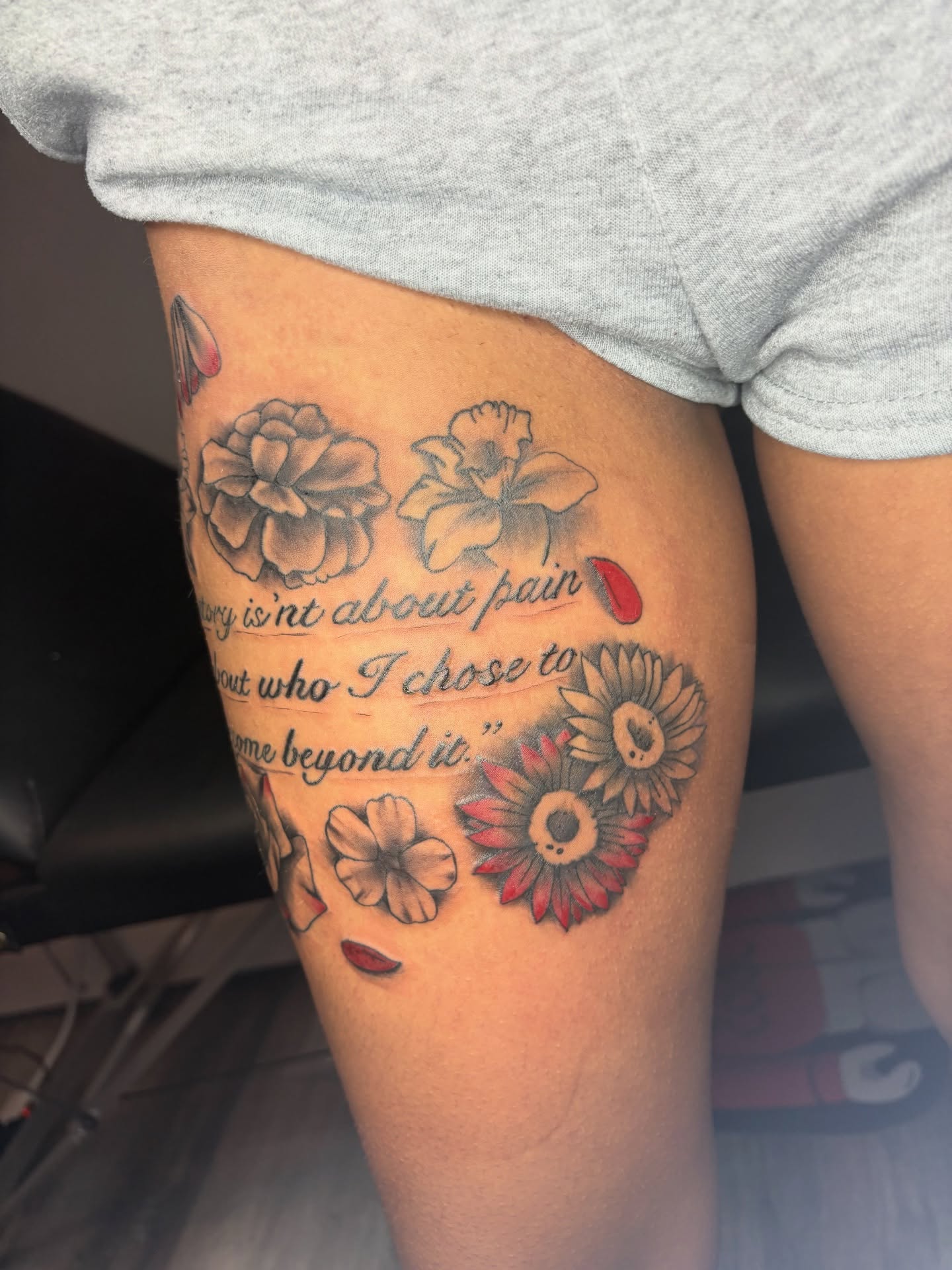 Flowers and quote dotwork tattoo on the thigh by Maleek Inkz