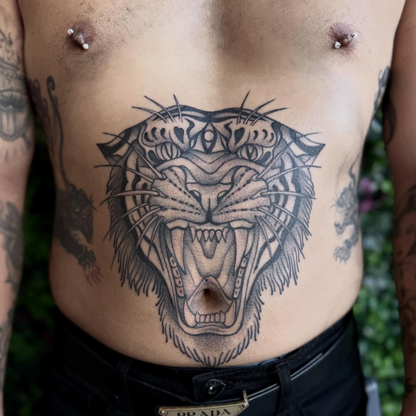 Roaring tiger black and grey tattoo on the chest by Sasha “Sashimi” Shabasov