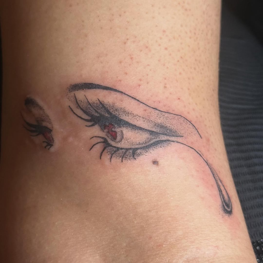 Anime eye with tear dotwork tattoo on the forearm by Danny Garcia