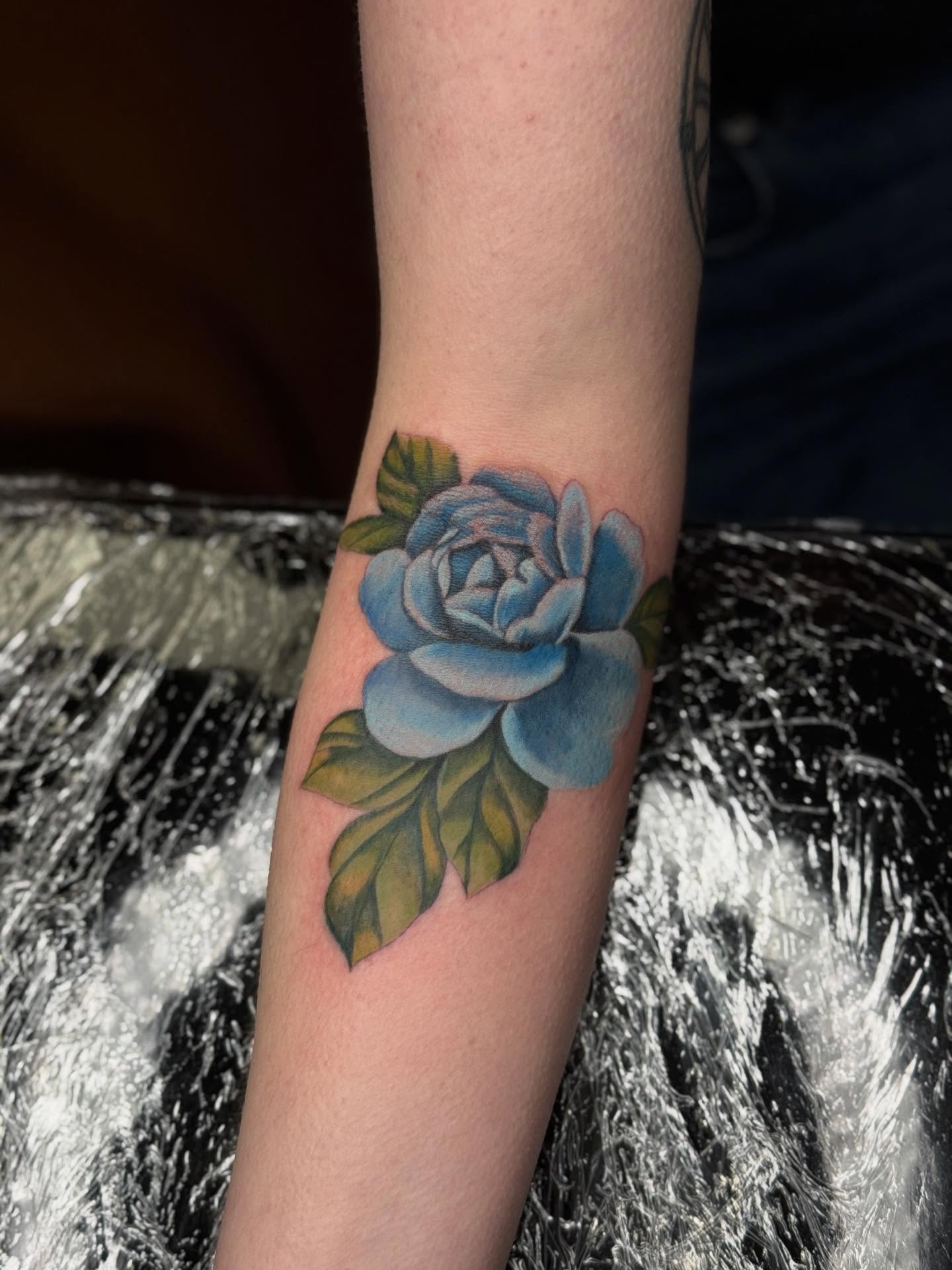 Blue rose realism tattoo on the forearm by Ashley Hsiung *Panda*