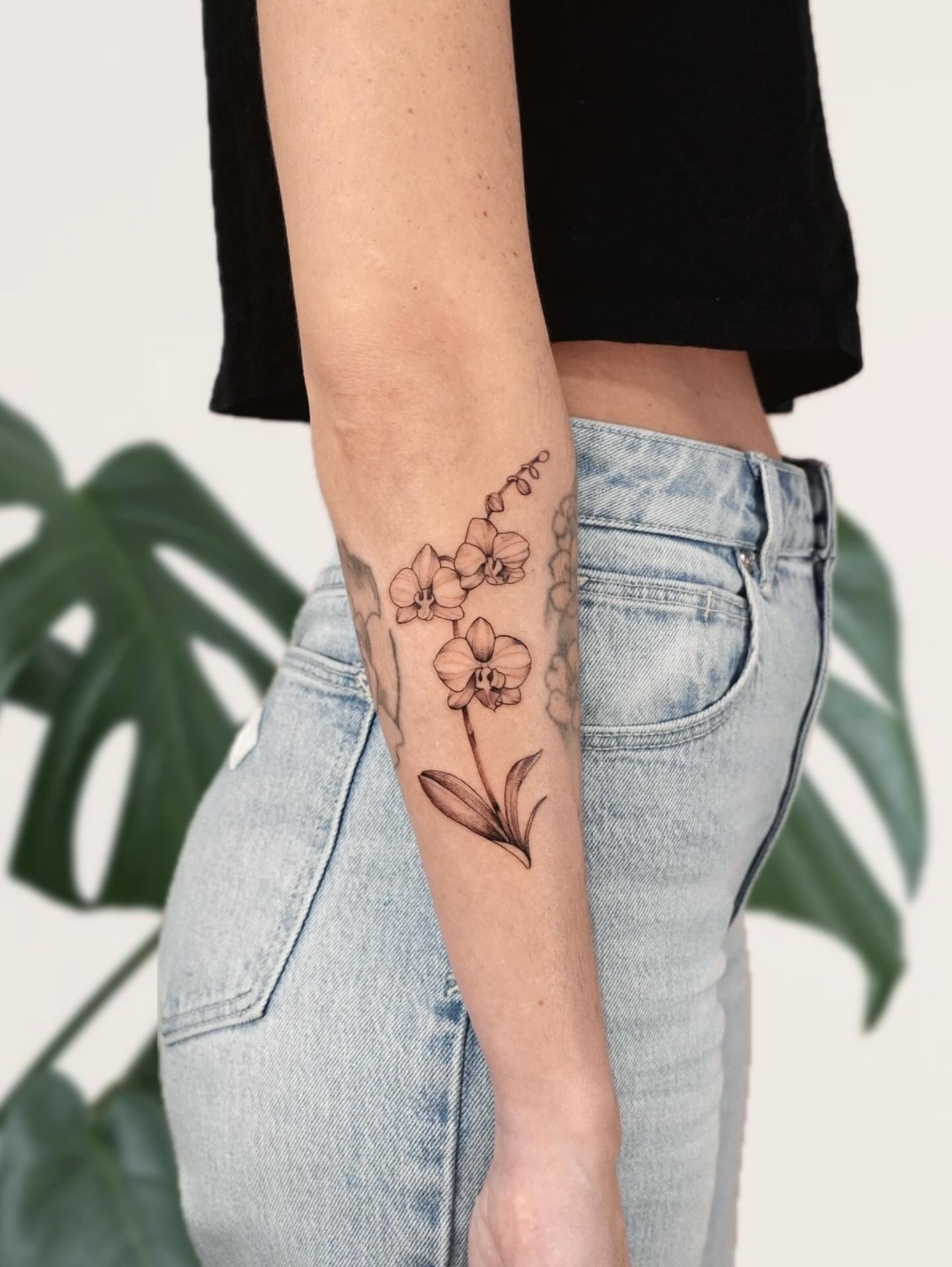 Orchid black and grey tattoo on the forearm by Marianna D D King