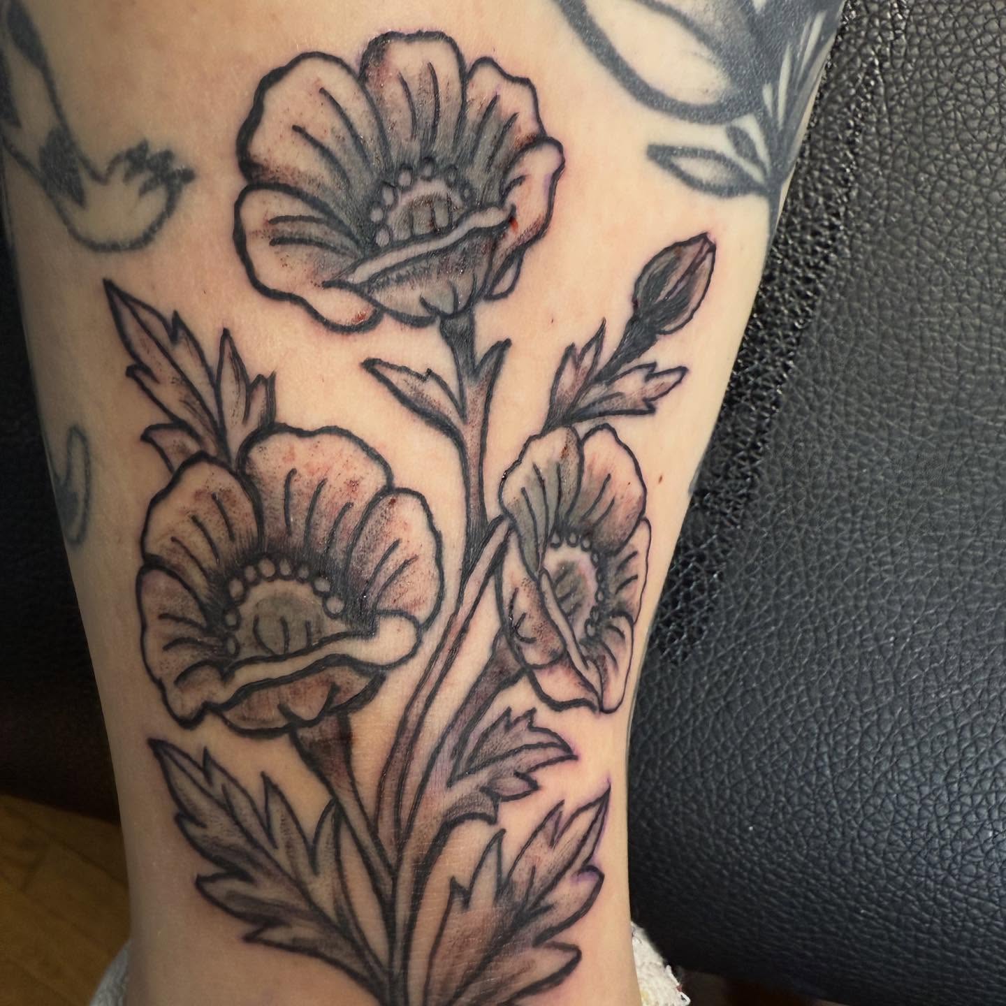 Flowers black and grey tattoo on the forearm by Jillian Pardy