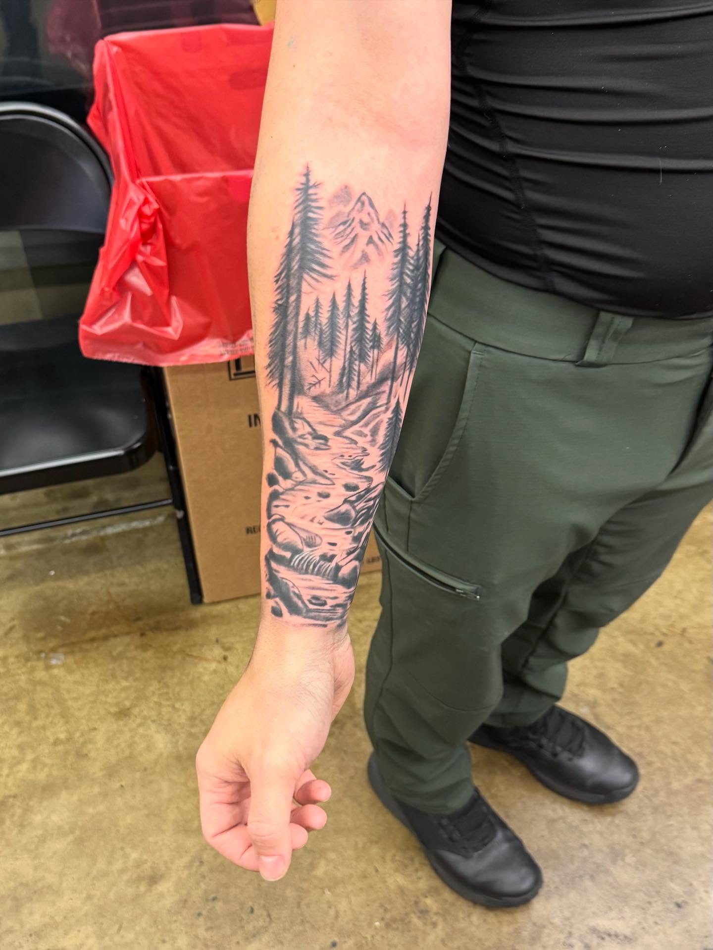 Mountain stream black and grey tattoo on the forearm by Willi Tattoos👹