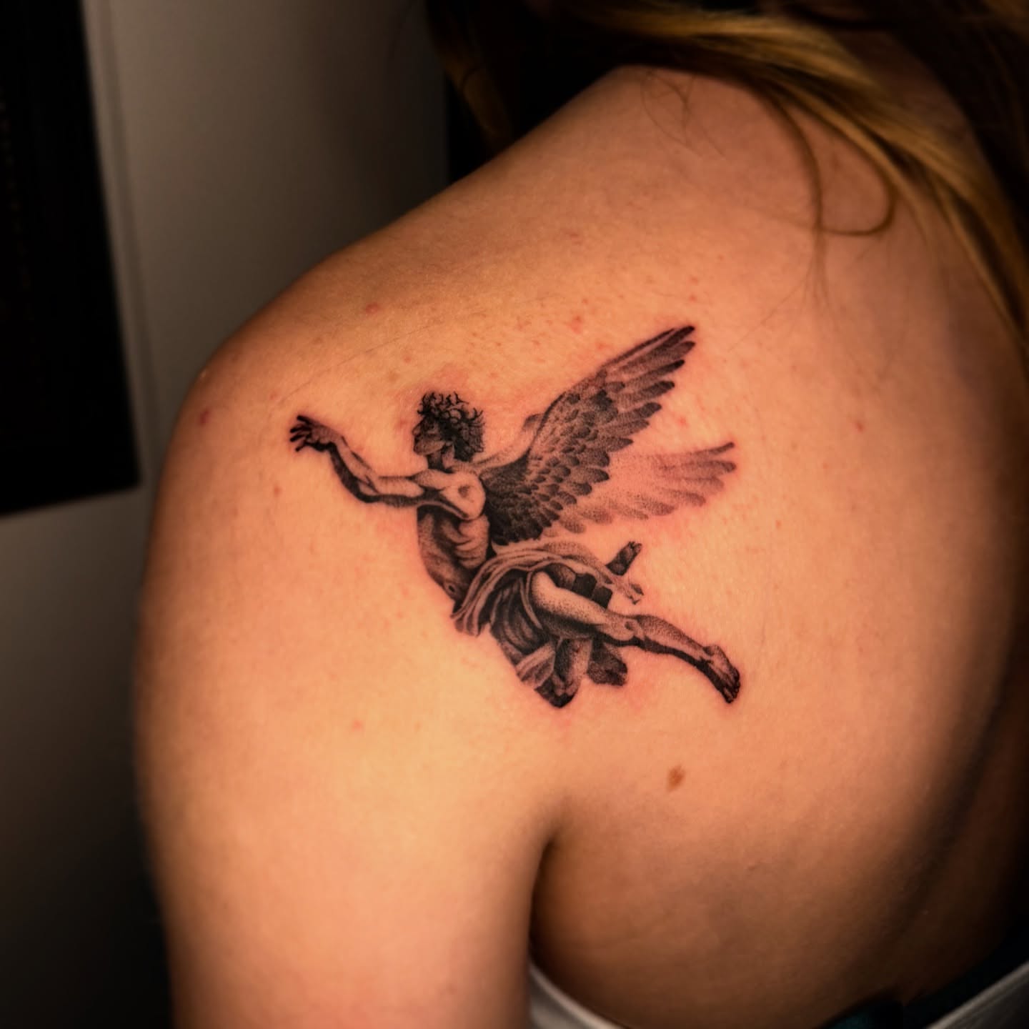Winged figure black and grey tattoo on the shoulder by Jacob Deirfield, Circleville, Ohio