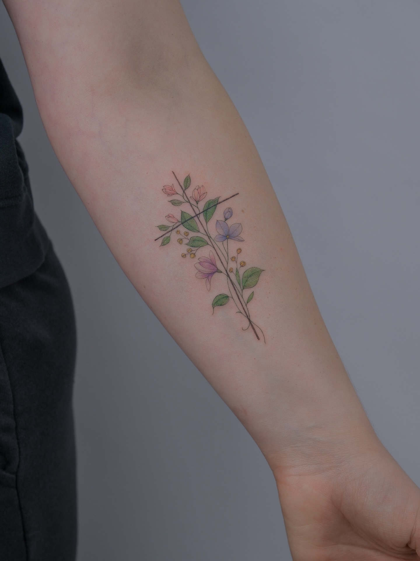Floral arrangement watercolor tattoo on the forearm by Tattoo in Charlotte NC, Charlotte, North Carolina