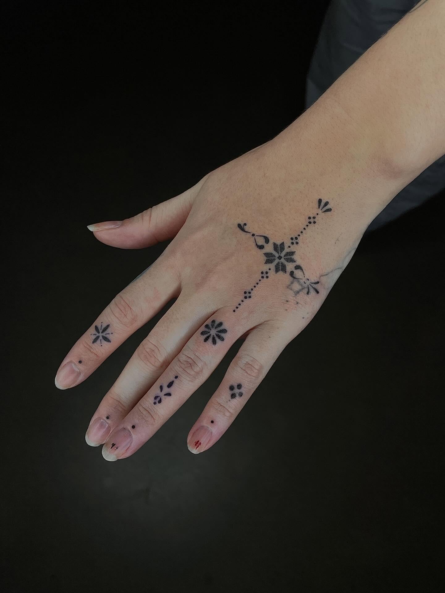 Floral and geometric design dotwork tattoo on the hand by Thiên Hồ