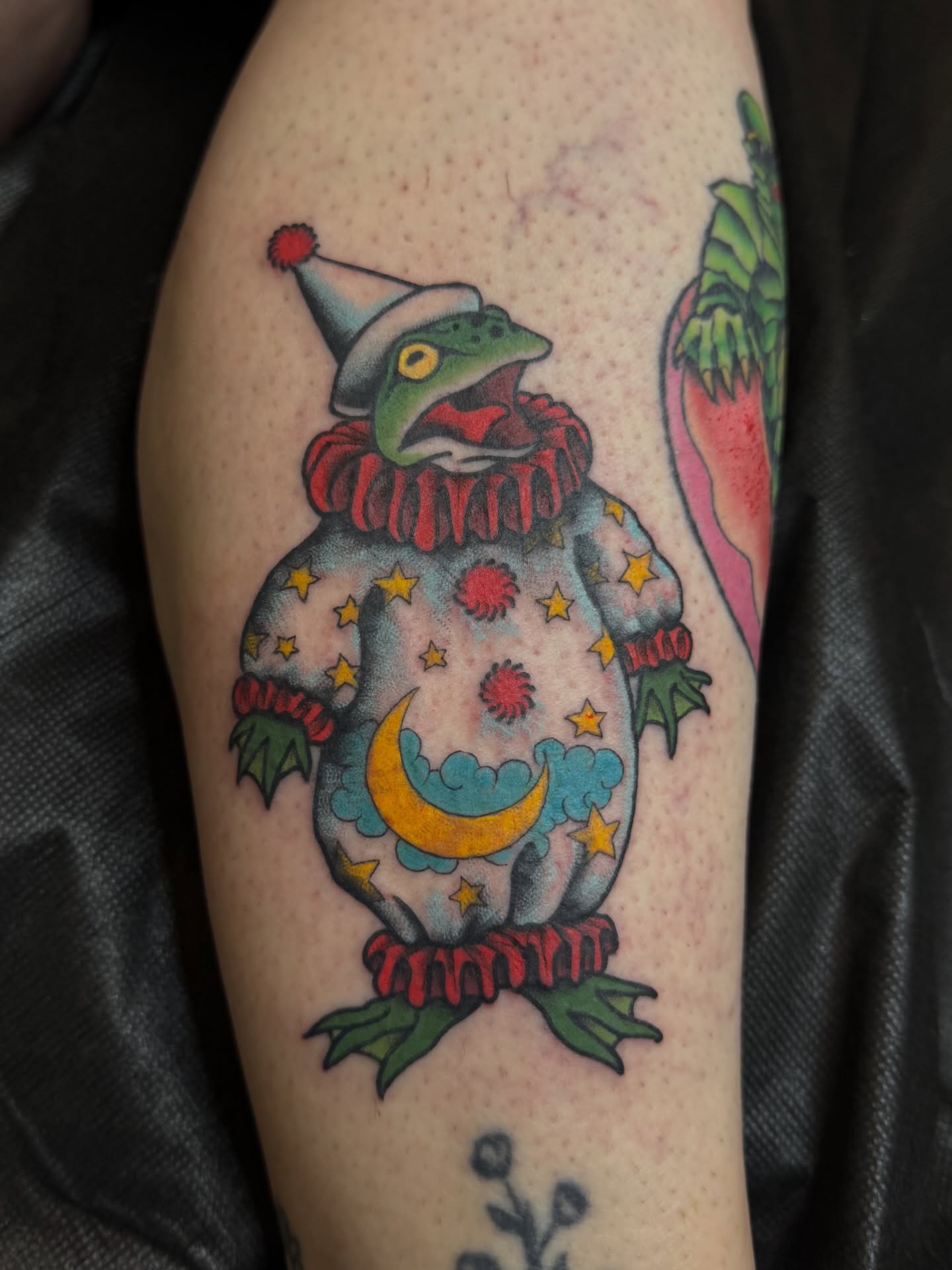 Clown frog American traditional tattoo on the thigh by Anna Wall