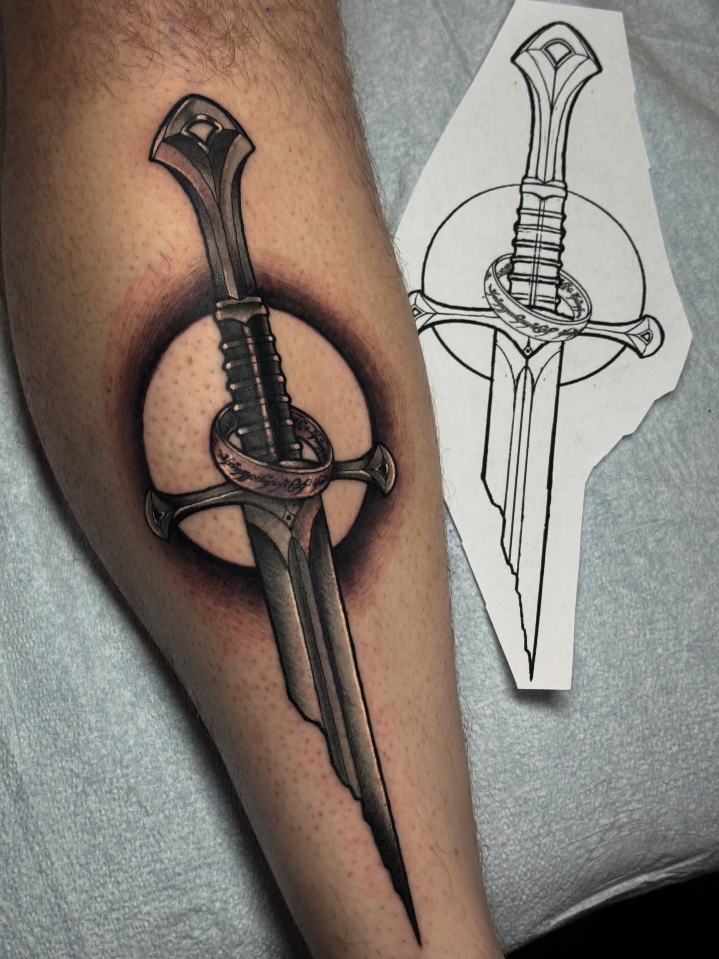Sword black and grey tattoo on the forearm by Mitch McGarry